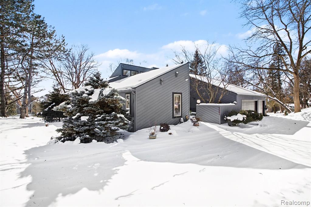 Architecturally inspired by Frank Lloyd Wright Prairie style design, The Doleman House is a Mid Century Modern walkout ranch offering 5 bedrooms, 3.1 baths, and a Cass Lake setting within Herndons Cass Lake Estates. This custom residence emphasizes natural materials, thoughtful design, and a strong connection to its surroundings. The open main level features wide four foot hallways, elevated beam ceilings, expansive windows, and extended interior sightlines that create a light filled living environment with lake and landscape views. A fieldstone fireplace constructed from stones gathered on site anchors the main living area. Rift and quartered white oak flooring with a Swedish finish runs throughout the main level. The kitchen includes Sub Zero refrigeration, under counter freezer drawers, a Wolf five burner cooktop and double oven, Bosch dishwasher, and custom cabinetry integrated into the space. The walkout lower level offers additional finished living space with bamboo flooring, hand cut green tile surrounding the fireplace, pickled white knotty pine ceilings, and direct access to the exterior. Exterior features include a private courtyard with Japanese maples, Trex decking overlooking Cass Lake, and landscaped grounds with a mature Ash tree. An irrigation system sourced from the lake services the landscape. The sale includes the primary residential parcel along with an additional lakefront parcel, providing added separation from neighboring properties and contributing to the overall lakefront setting. Parcel identification number 18 04 379 024 is included. Additional features include a custom birch office or library that may be used as a fifth bedroom, a Japanese art inspired tile bath, newer vinyl windows, an advanced water softening system, and a new roof with new kitchen skylights recently completed.
