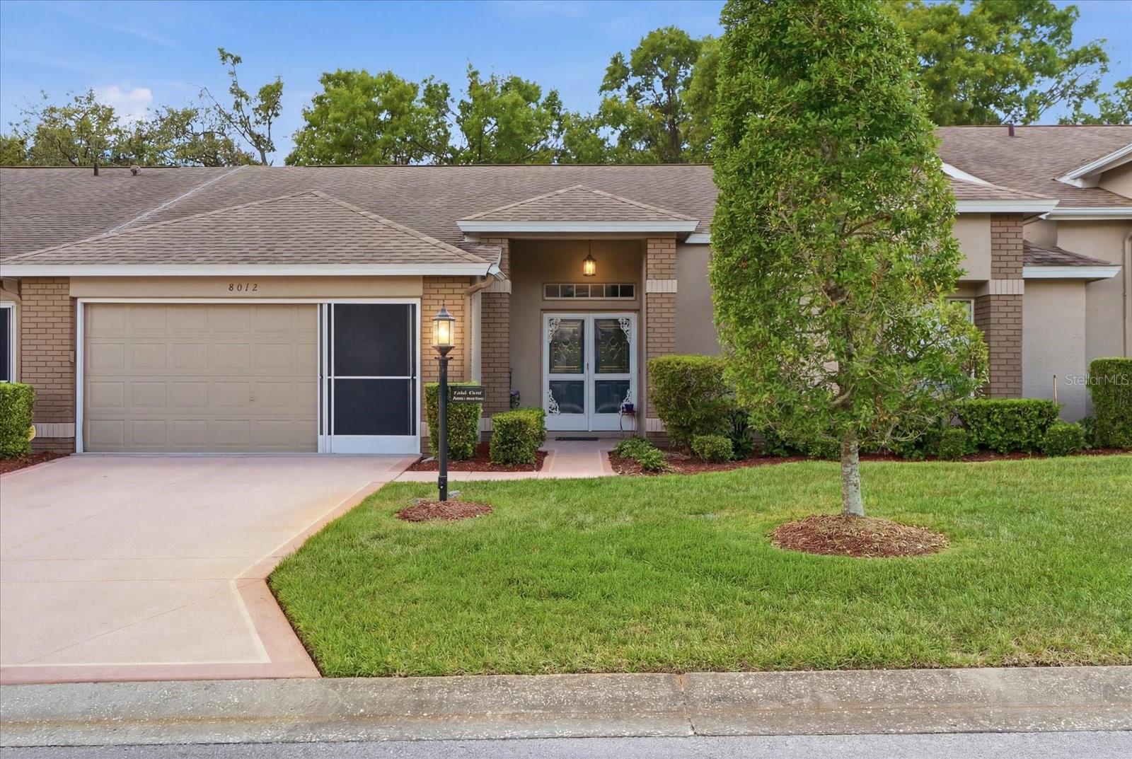 Welcome to carefree, resort-style living in the highly sought-after Timber Pines 55+ gated community!This beautifully maintained villa offers an inviting open layout designed for both comfortable everyday living and effortless entertaining. Updated flooring flows throughout the kitchen and main living areas, creating a fresh and modern feel the moment you step inside through the elegant double front doors.The spacious primary suite serves as a private retreat, featuring an ensuite bathroom with dual vanities and the rare convenience of two walk-in closets. The large living area seamlessly connects to sliding glass doors that open to a peaceful backyard setting where manicured landscaping, mature trees, and a tranquil nature view create the perfect place to relax and unwind.Additional highlights include an interior laundry room with direct access to the oversized two-car garage complete with a screened enclosure, allowing you to enjoy fresh air while keeping pests out. Beyond the home itself, Timber Pines offers an unmatched lifestyle. This premier gated 55+ community features championship golf courses, swimming pools, fitness centers, pickleball and tennis courts, a performing arts center, on-site dining, and a vibrant social calendar filled with activities and events year-round.Whether you're searching for a full-time residence or a seasonal escape, this is an exceptional opportunity to enjoy low-maintenance living in one of Hernando County's most desirable active adult communities. Roof was replaced in 2018 and the HVAC was replaced in 2016.