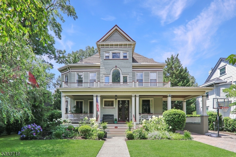 Quintessential circa 1883 Queen Anne Victorian, beautifully renovated & restored, situated in a most sought-after historic Cranford neighborhood boasting a vast array of architecturally significant homes shown on the "map of Roosevelt Manor". 14 rooms, 5 BR's & 2.2 BA's. Maintained impeccably. Original carriage house (storage today) w/attached garden room. Exquisite perennial gardens throughout the 1/4 acre property & beautifully hardscaped paver terrace, patio, & social area. Full width open front porch on either side of the original front doors & porte cochere w/room for 2+ cars. Entry vestibule opens to foyer with fireplace. Double living room with full glass picture window. Formal dining room w/beamed ceilings & triple bay windows. Two sets of french doors open to the front porch. The kitchen 24x20 features custom maple cabinetry and a suite of stainless appliances. Breakfast island seats 4. Informal dining room adjoins as well as extra large pantry, mudroom, and office area.  The family room addition 17x16 is seamless and opens to the terrace & backyard. Five bedrooms, office, sitting room & two full baths on the 2nd & 3rd levels. Finished basement with recreation room, half bath, laundry, utility & storage rooms. Multi-zone gas heat & CAC. 2025 Timberline roof; new plywood & 30 yr. shingles. Just 3 blocks to award winning DOWNTOWN CRANFORD & NYC transportation. Recipient of the Cranford Preservation Award & was featured on the 2023 Garden Club of Cranford Garden Tour.