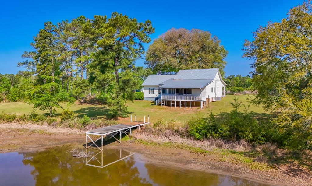 Lovely white farmhouse on 25.5 acres and a pond. This  beautiful three bedroom two and one half bath home has recently been remodeled to include new kitchen with soaring ceilings and top of the line appliances, New main bedroom with the same high ceilings and designer bath. Two large barns, chicken coop. Nice screened porch overlooks new back deck and tranquil pond. The property is set up for the hunter with a food plot and walking trails. Main barn has an area for home business, including  a post harvest  area and a cool bot for keeping vegetables or flowers old. Two large master suites