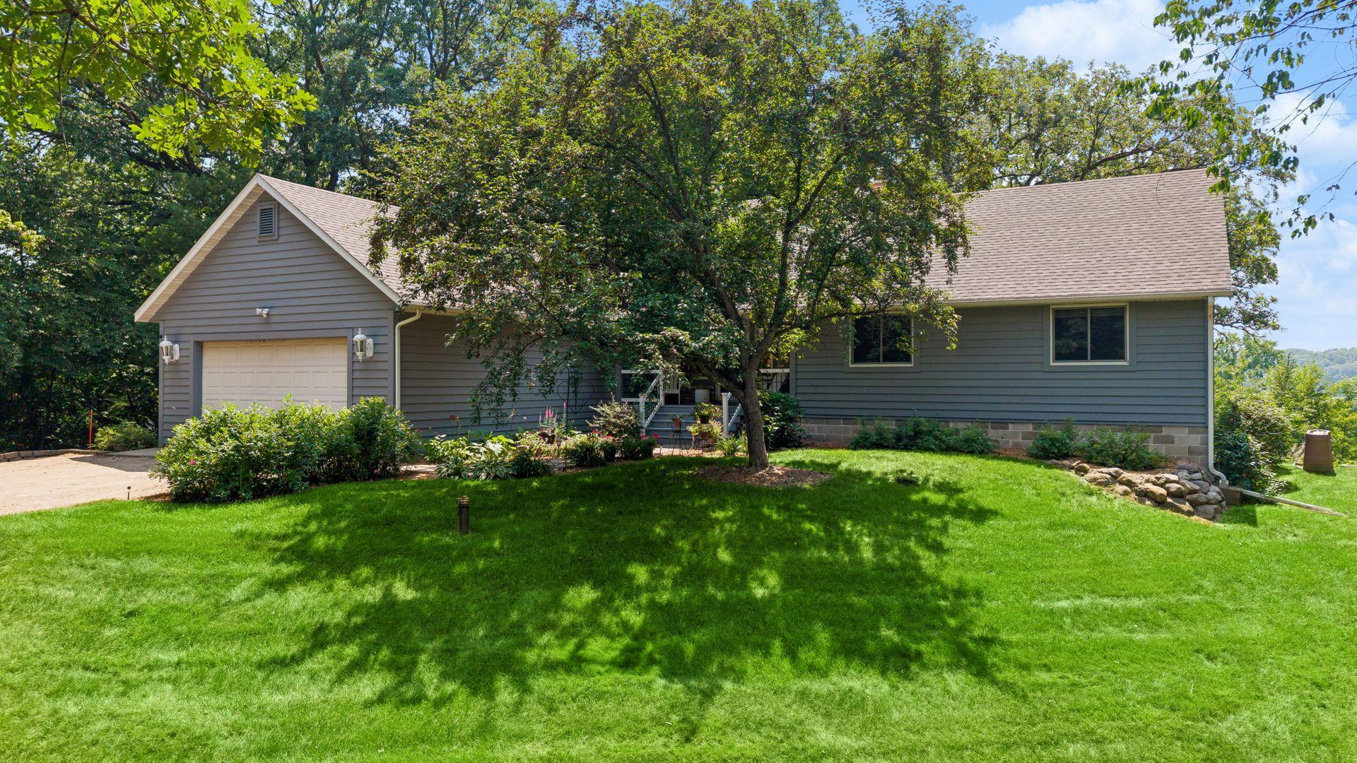 Enjoy this stunning one-level walkout on a private 2.83 acre setting that offers an exceptional 160 feet of lakeshore and dock access on Birch Lake! Upon entering you’re greeted with a generously sized living room that includes hard-wood floors, a brick surround gas fireplace and a wall of windows overlooking the backyard and lake. The kitchen offers an ample amount of white cabinetry, granite counters, white subway tile backsplash and stainless appliances. The dining room includes walkout access to the oversized cedar deck. The main level primary suite offers private views of Birch Lake, a walk-in closet, and an oversized primary bathroom with a separate tub and shower along with double sinks. Two additional bedrooms and a full bathroom complement the main level. The lower-level family room is set up perfectly to entertain your guests with walkout access to the back patio, a wood burning fireplace with brick surround and plenty of spectacular lake views. A private guest bedroom with a walk-in closet and another full bathroom completes the lower level. Additional features include plenty of storage space, an exterior storage shed, a new AC and furnace in 2024, new roof in 2024, Anderson Windows and a new septic mound system installed on 6/2026.