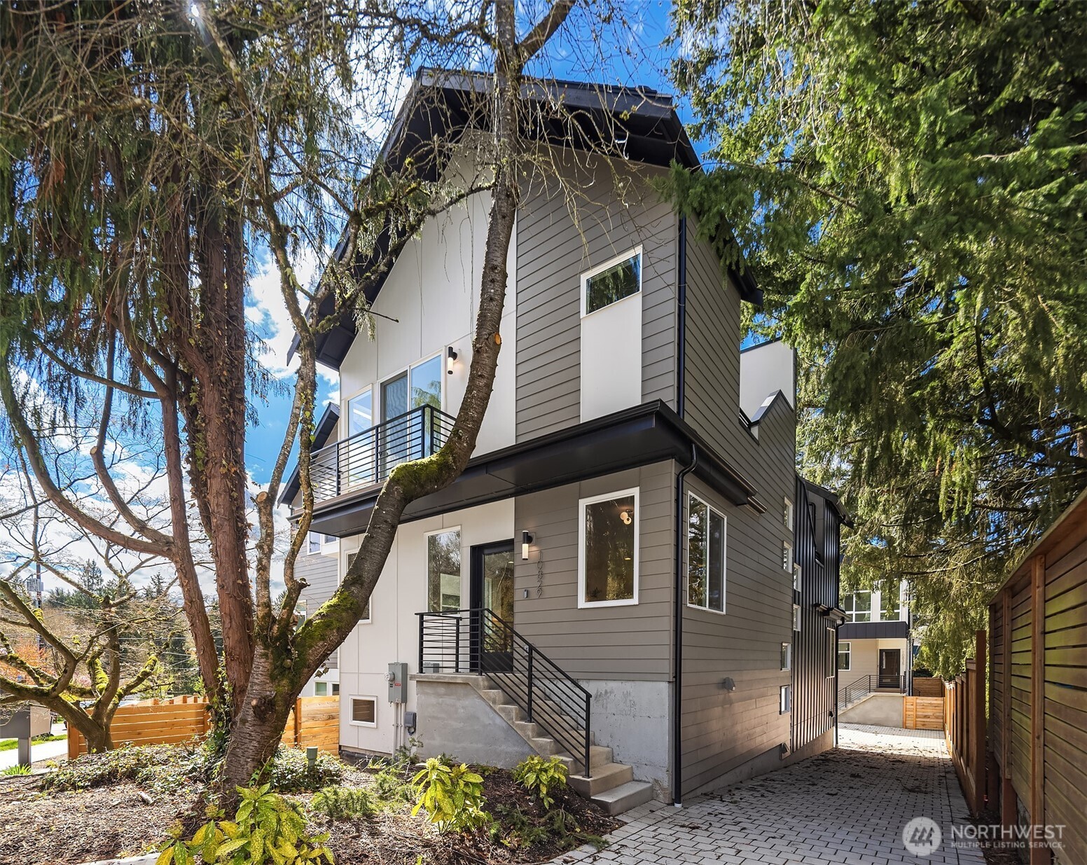 Enjoy modern comfort in this thoughtfully designed home within a new 12-home community by Prestigious Builds. Ideally located in Victory Heights, the main level offers an open kitchen with island seating, while floor-to-ceiling windows fill the living and dining areas with natural light. The lower level features two bedrooms complemented by a full bath. Primary suite spans the entire top floor, creating a private retreat with an en-suite bath. Rooftop deck and fully fenced yard provides ample outdoor space for pets, gardening, or entertaining. Off-street, EV-ready parking adds everyday convenience. All within close proximity to shopping, dining, I-5 and the Northgate Light Rail. Photos show the model home, 10829.