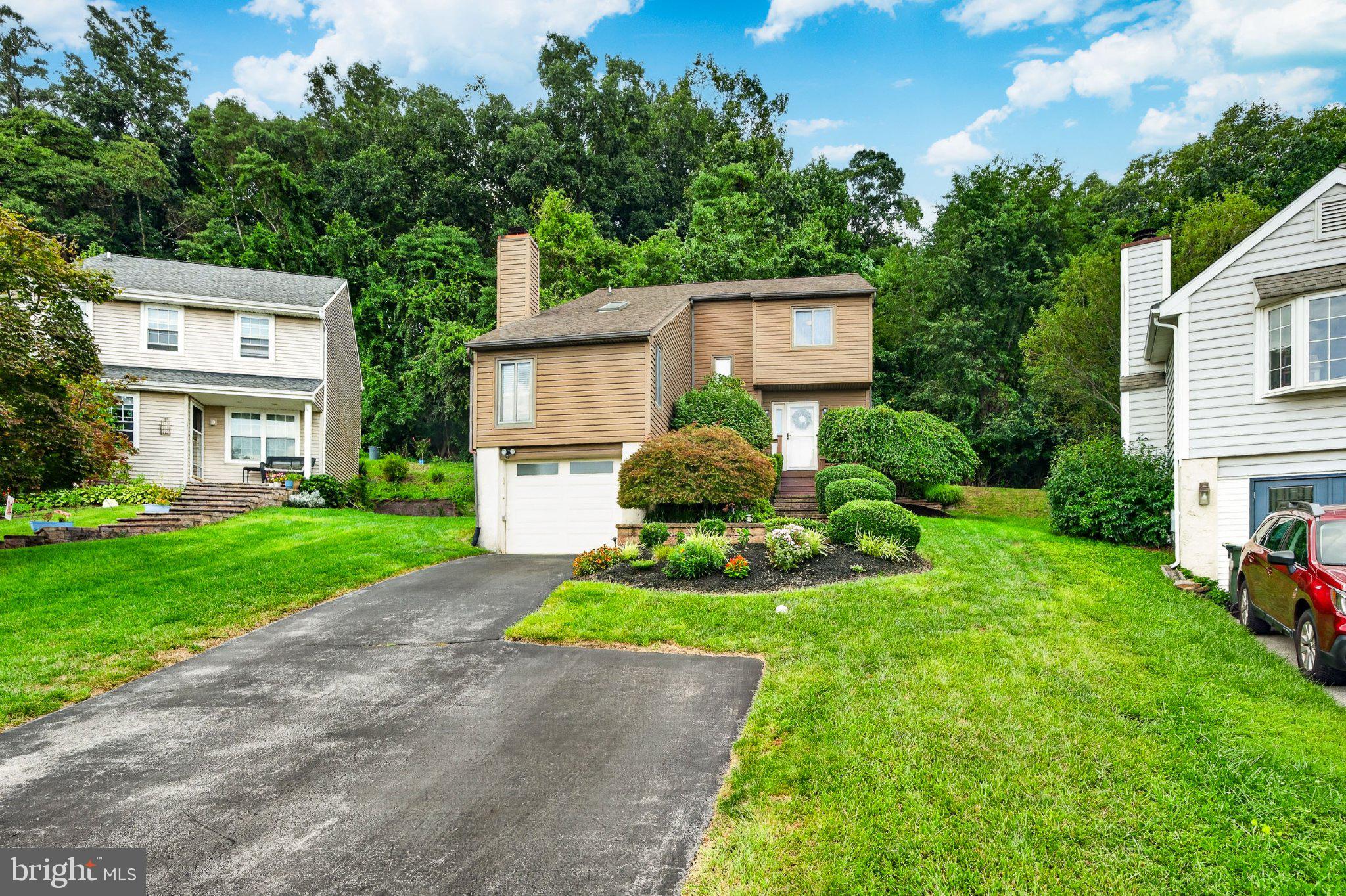 Welcome to 1312 Rhode Island Cir, a charming 3-bedroom, 2.5-bathroom single-family home nestled in the desirable Brandywine Greene community of Downingtown and located within the award-winning Downingtown School District! Approach the front door via the paver front steps, surrounded by beautiful landscaping, and enter into the welcoming vaulted entryway. The main living level offers a functional and inviting layout designed for both everyday living and entertaining. The sun-filled family room features large windows, a skylight, and a cozy fireplace, creating a warm and comfortable space to relax. The eat-in kitchen boasts stainless steel appliances, sleek countertops, a stylish backsplash, and plenty of room for a table beneath the large window. Just off the kitchen, the dining room flows seamlessly into the living room, complete with carpeting and sliding glass door access to the private back paver patio, making indoor outdoor entertaining a breeze. A convenient half bathroom completes the main level. Upstairs, retreat to the primary bedroom, featuring comfortable carpeting, a walk-in closet, and a private ensuite bathroom. Two additional bedrooms offer plenty of space for family, guests, a home office, or whatever your lifestyle requires. They share easy access to the full hall bathroom. The partially finished basement provides even more flexibility, with additional living space that can be used as an entertaining den, home gym, kids' play area, or whatever best suits your needs. The unfinished portion provides laundry and ample storage space. Step outside and enjoy your own private outdoor retreat! The spacious paver patio overlooks a serene wooded backdrop and offers plenty of room for outdoor dining, entertaining, or simply relaxing and enjoying the peaceful surroundings. Conveniently located with easy access to West Chester Borough, Downingtown Borough, Exton, local parks, shopping, dining, and more, this home offers the perfect blend of quiet community living and everyday convenience. Don't miss the opportunity to make this inviting Downingtown home your own!