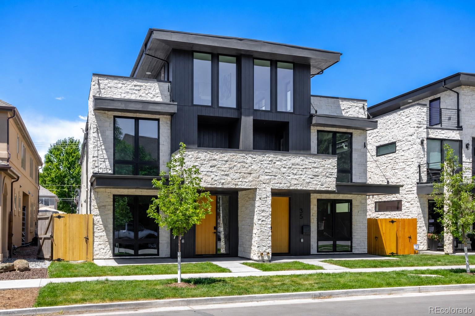 Thoughtfully designed and expertly crafted, this Cherry Creek duplex reflects PBG's commitment to timeless architecture and exceptional quality. Located less than a 10-minute walk from premier dining and boutiques, the 5-bedroom, 5-bath residence blends organic materials with clean, contemporary design. With every other residence in the project sold almost immediately, this is the final opportunity to own one of PBG's sought-after homes. This is the only south-facing unit with a private rooftop deck.  The exterior showcases a thoughtful composition of natural stone, rich wood accents, and clean architectural lines, resulting in timeless curb appeal. Inside, wide-plank engineered white oak flooring and expansive windows flood the home with natural light, while warm wood slat ceiling accents and a custom arched fireplace reinforce the home's elegance. At the center of the home, the chef's kitchen features Calacatta Enzo countertops, custom American-made cabinetry, walk-in pantry, and surrounded by Thermador appliances. Upstairs, the primary suite offers a private balcony, gas fireplace, and wet bar. Spacious primary bath is defined by freestanding soaking tub, glass-enclosed dual-head shower, separate WC, and heated floors. A secondary en-suite bedroom with outdoor balcony and spacious laundry room completes the level. The rooftop level offers flexibility with an office that can be converted to a bedroom easily, bedroom, ¾ bath, wet bar, and expansive private deck ideal for entertaining that supports a jacuzzi. The finished basement with 10-foot ceilings expand the home with a recreation area, wet bar, full bath, additional bedroom, and optional fitness room/bedroom. A private backyard with covered patio, gas hookup, and TV prewire extends the indoor/outdoor lifestyle. Detached two-car garage includes 220V capability and optional storage. PBG industry leading 2-year builder’s warranty/8-year structural warranty. Prewired for speakers | No HOA |Buyer to Verify All
