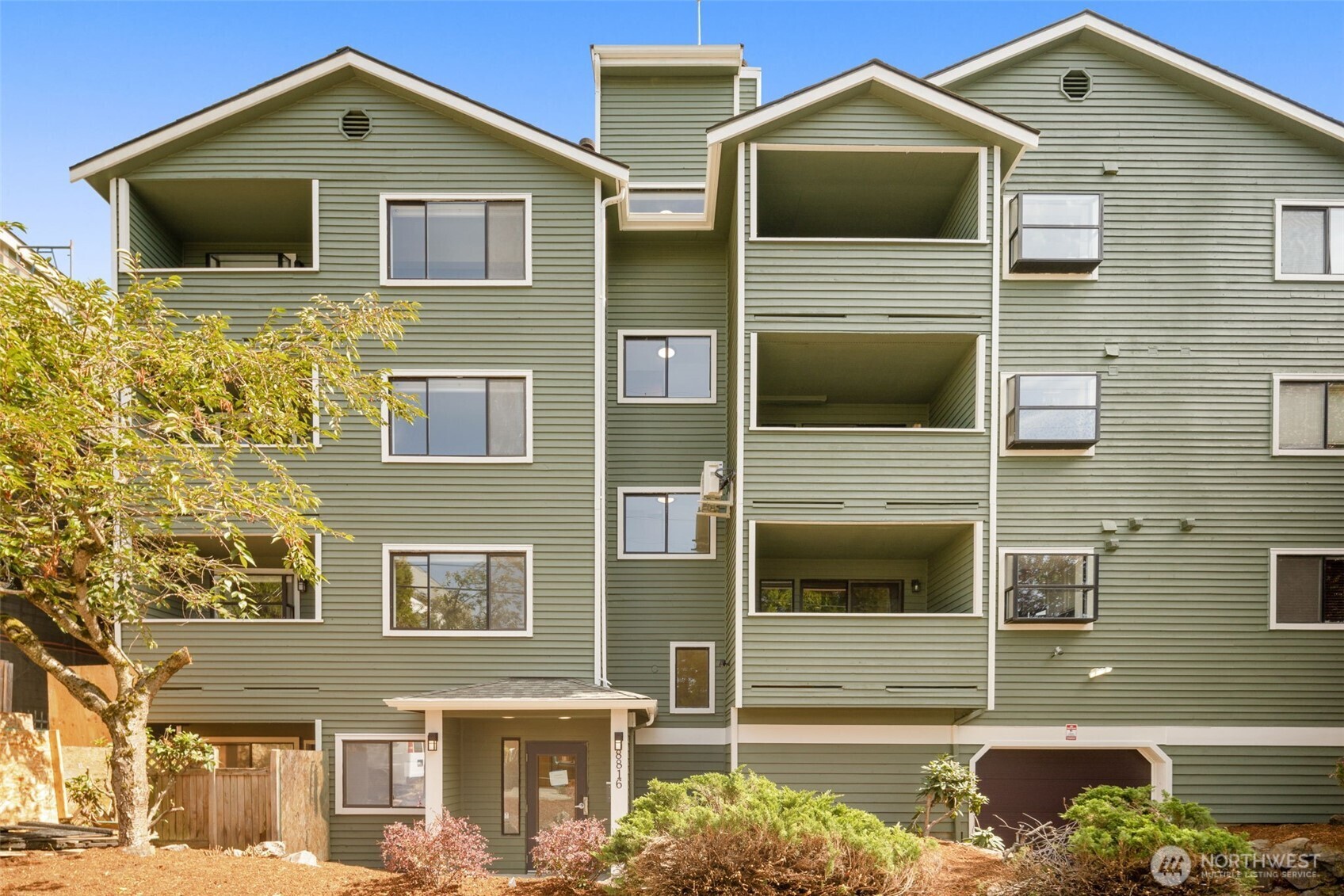 Welcome to this 2-bedroom, 1.5-bath condo in a convenient North Seattle location. Bright and inviting, the open living and dining space features a cozy fireplace, large windows, and access to a private covered balcony. The kitchen offers granite countertops, warm cabinetry, stainless steel appliances, and a charming garden window perfect for your indoor plants. Two comfortable bedrooms, in-unit laundry, and secure parking add everyday convenience. Well maintained with fresh paint and carpet, this home is move-in ready. Well situated near Green Lake and Greenwood with quick access to hwy 99 and I-5, this is a great opportunity to own or invest in Seattle.