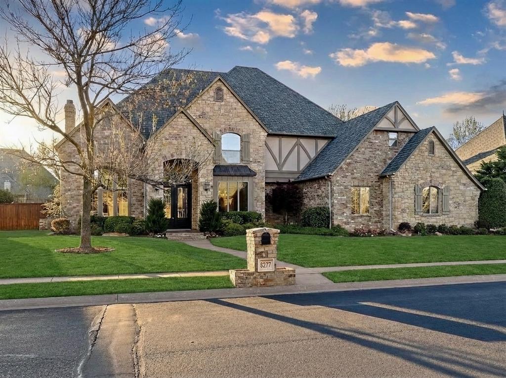 Wind through the streets of Cobblestone Park 3 to a quiet cul-de-sac, where you’ll find this lovely two-story Country French-inspired home. Built in 2004 with superior craftsmanship, it features a natural stone & brick facade, wood shutters, arched windows, & subtle Tudor accents. Solid & immaculately maintained, it feels nearly new! The resort-style backyard on this .44-acre lot is a private oasis. Under a wooden pergola with string lights is a dining area and built-in outdoor kitchen with a grill, mini-fridge, and bar seating. Multiple concrete patios zoned for dining, lounging, and relaxing poolside. A curved walkway winds around the heated pool with artisan diving rock, while a separate rock waterfall is integrated into the landscape of colorful shrubs, specimen trees, and custom rockwork. Inside is a blend of traditional and transitional styles. The two-story foyer leads to an office with French doors, built-in bookcases & coffered ceilings, a formal dining room with pass-through wine fridge, and a family room with 20’ ceilings & stone fireplace flanked by built-in bookcases with accent lighting. Kitchen with center island, breakfast bar, pantry, dining space, granite countertops, SS appliances, gas cooktop and built-in fridge. First Floor Primary Suite with sitting area & Primary Bath with his and her sinks, makeup vanity, whirlpool tub, & huge closet. Upstairs are 3 big bedrooms with walk-in closets, 2 full baths, and an oversized bonus room ideal for a home theater, pool table, second office, or hobby room. 2022 Roof, Class IV Shingle. New: AC, Water Heater, All Carpet/Pad, outdoor fridge, interior paint, lighting, disposal, window glass replacements. Cobblestone offers peaceful seclusion, sidewalks, gated entry, ponds, & walking trails. Easy access to the Kilpatrick, Mercy Hospital, the Integris Medical Complex, restaurants,& shopping. This home blends comfort, style, & outdoor living in a way that’s hard to find. Once you’re here, you won't want to leave!