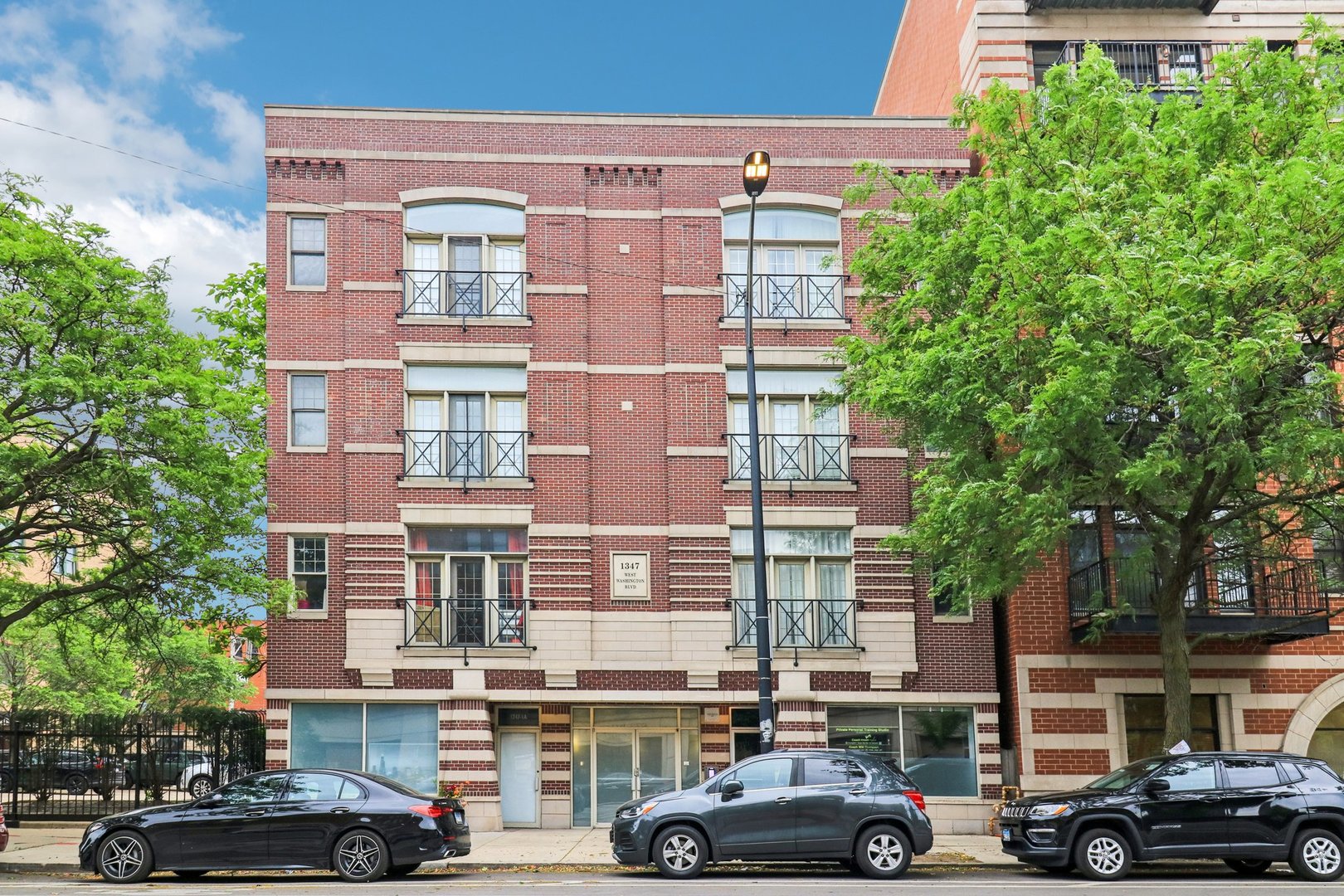 Welcome to this stunning condo in a boutique elevator building with two private outdoor spaces! This beautifully designed home features an open-concept layout, hardwood floors throughout and a cozy fireplace in the living room. The chef's kitchen boasts granite countertops, a large island, custom cabinetry, and modern finishes. The spacious primary suite includes dual closets, a dual vanity, separate shower, and a soaking tub. The second bedroom is spacious and has a large closet and the hall bath features a walk-in shower. Enjoy two private outdoor spaces - a balcony off the living room and a deck off the primary suite. One attached garage parking space included in the price. The building features several recent updates including: new garage door and opener (2025), new roof (2025), updated intercom/security/locks (2025), and new front entrance door (2024). Just blocks from Skinner Park, the shops & restaurants on Randolph Street and with easy access to 90/94 & 290 this West Loop gem truly has it all!