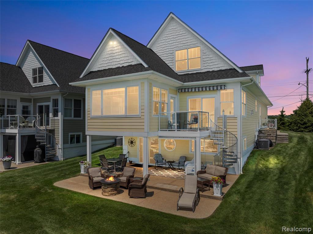 Exquisite prime end-unit lakefront estate, custom-built and offering three levels of refined living. This signature residence stands apart in design, craftsmanship, and privacy, capturing breathtaking views of Anchor Bay while blending sophistication, comfort, and an unparalleled waterfront lifestyle.The main level centers around the reimagined kitchen, boasting quartz countertops, a designer backsplash, and elegant cabinetry, flowing seamlessly into a sunroom with panoramic lake views. An inviting living room with a beautifully updated fireplace creates a warm gathering space, while a sunlit bedroom, full bathroom, and convenient laundry room complete this floor.Upstairs, the private quarters include three spacious bedrooms and two updated full baths. The highlight is a stunning primary suite with a spa-inspired bath and beautiful views of Anchor Bay.The walkout lower level is an entertainer’s haven, complete with a full wet bar, dining and lounge areas, utility room, and custom storage—anchored by a cozy fireplace. Step outside to the aggregate patio and immerse yourself in sweeping waterfront vistas.An oversized attached garage accommodates two large vehicles with abundant storage. Your private shoreline features two boat slips, an electric boat hoist, an electric dinghy/jetski hoist, and guest docking—designed for those who value convenience and luxury on the water. From world-class fishing and boating to kayaking, skating, and snowmobiling, every season brings a new way to enjoy life at the lake.Ideally positioned, this exceptional residence is just a leisurely boat ride or scenic bike trip from the vibrant town of New Baltimore, offering fine dining, boutique shopping, a wine bar, farmers market, and lively community events. Just 10 minutes from the expressway, this estate blends serene lakefront living with easy access—a rare opportunity to own Anchor Bay’s signature jewel.