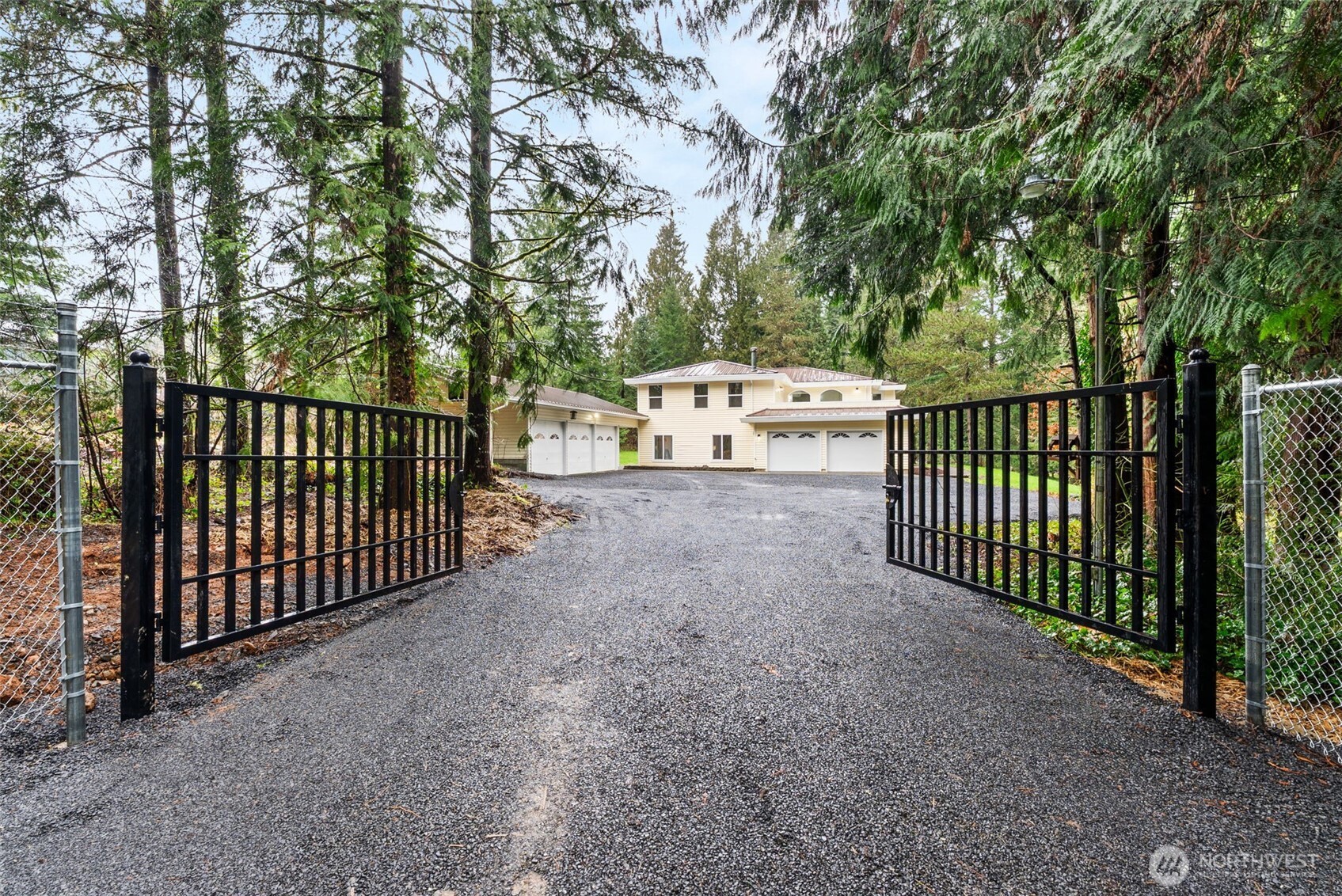 Like new and fully renovated, this quality home offers over 3,200 sq ft of well-designed living space. A sweeping spiral staircase welcomes you in the formal entry. The main floor features a custom kitchen with granite countertops, large island with storage and seating, dining area, and a spacious family room with wood stove for comfort and ambiance. A wet bar adds great entertaining space. Formal living room with large fireplace and half bath complete the main level.  Upstairs you’ll find a large primary bedroom with 5-piece en suite and walk-in closet, plus three additional large bedrooms—each with walk-in closets. A large laundry room adds convenience, and the upper-level sundeck provides a quiet place to enjoy the surroundings. A new heat pump ensures year-round comfort.  Set on over an acre with mature perimeter trees for privacy and an estate-like feel. Attached 2-car garage plus a large detached 3-bay garage with shop area and covered storage—ideal for hobbies, equipment, or extra vehicles. Conveniently located just 5 minutes to I-5 and positioned midway between Seattle and Portland. A great opportunity for space, privacy, and value.