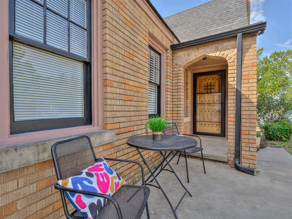Welcome to one of the most charming places to live in OKC! Located in the urban core, Miller Neighborhood is on the national historic registry and offers a vibrant, vintage lifestyle with unbeatable access to downtown, the popular Plaza District, and major highways. This stunning 1930 Tudor delivers the perfect blend of classic style and modern convenience, making it truly move-in ready.

Step inside and be instantly greeted by a dramatic, tall barrel ceiling and enviable original craftsmanship. Period details like the unique arched doorway, a matching wall niche, intricate fireplace masonry, and a front door with a speakeasy create a memorable atmosphere. All of this charm is set against gorgeously refinished hardwood floors that flow throughout the home.

The home has been meticulously updated for modern living. The kitchen and breakfast nook are a chef's delight, overhauled with designer solid stone countertops, custom storage, and stainless steel appliances. The full bathroom is equally luxurious, featuring a spa-like soaking tub, elegant Spanish tile, and a new vanity. You'll also appreciate the functional updates: 14 of 19 windows have been replaced with high-end, energy-efficient dual-pane glass, and the light fixtures throughout feel like jewelry, adding a designer pop of joy to every space.

As a rare urban treat, this modestly sized home boasts a functional two-car garage with an automatic opener, plus a generous backyard ready for your outdoor oasis or a game of fetch with your four-legged friend. Don't miss this beautiful, move-in-ready gem!