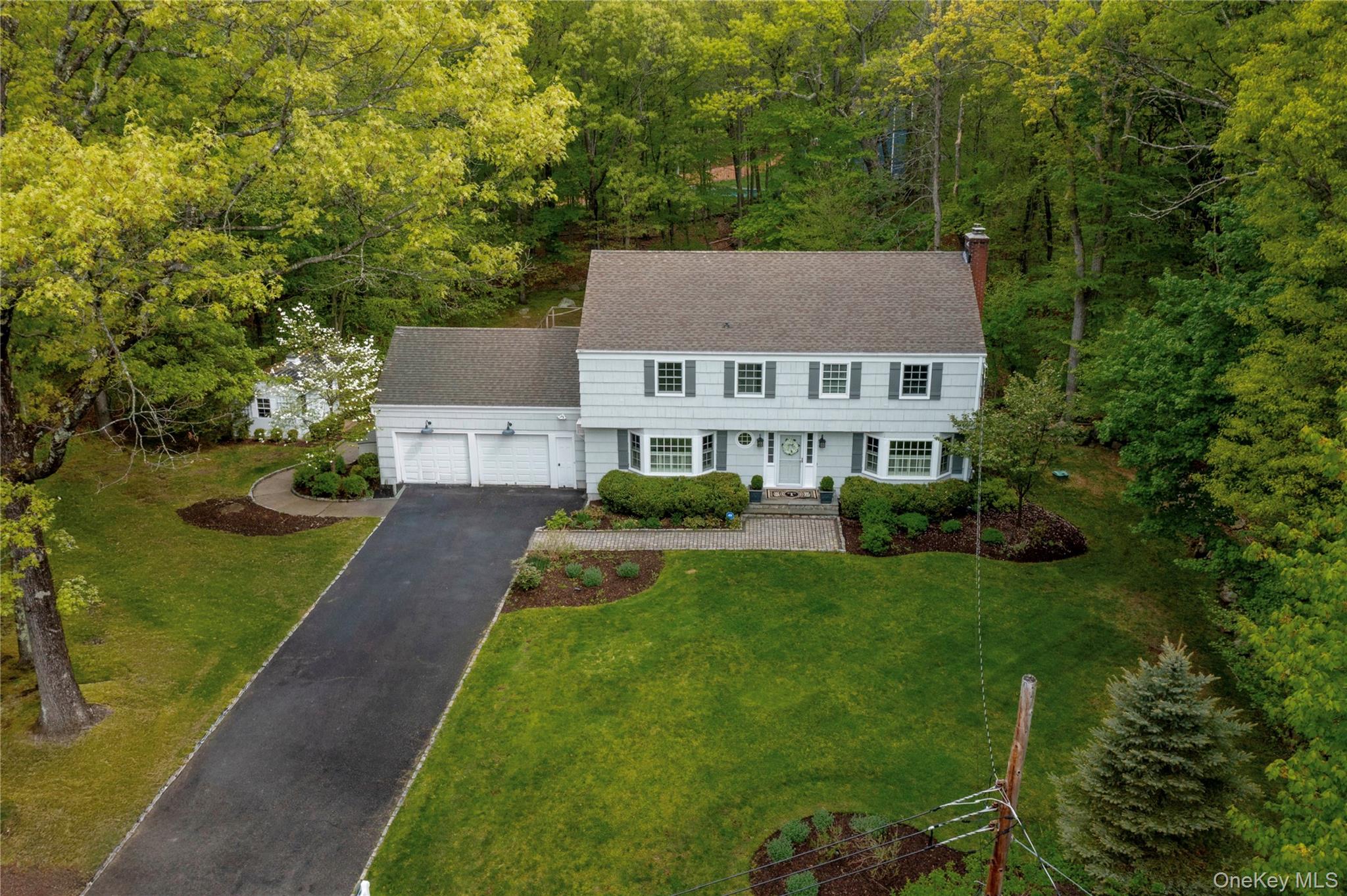 COUNTRY PERFECTIONThoughtfully sited upon over two beautifully landscaped acres against a scenic wooded backdrop, this meticulously maintained, updated five-bedroom classic colonial offers the perfect combination of peace, privacy, convenience, nature, and award-winning Katonah-Lewisboro schools in a quiet country setting.Move right in with nothing to do but plan your summer garden of flowers, fruit, vegetables… add a chicken coop for fun and fresh eggs… create a play space/cornhole/badminton/bocce/picnic area… the expansive fully-fenced garden framed by wisteria, lilacs and more is full of possibilities and the centerpiece of the back of the property.A welcoming entry foyer opens to sun-filled, beautifully appointed rooms scaled for relaxing daily life and entertaining, with a well-appointed kitchen, spacious dining room, living room with pellet fireplace, and family room.  A fabulous three-season room with walls of windows and door to large deck brings nature in, with surrounding views of the gardens and woodlands.The second floor features a primary en-suite bedroom with a walk-in closet and updated full bath, three additional bedrooms, updated full hall bath, and attic storage.The finished walk-out lower level with game and movie room provides additional space for entertaining, and a fifth bedroom with updated full bath — perfect for a home office, private guest/in-law/nanny suite, with a door out leading to the back lawn and garden.A spacious 2-car garage and charming potting shed provide ample storage for recreation and gardening supplies!Perennials and specimen plantings abound on the property, including flowering trees and shrubs such as lilac, wisteria, ornamental cherry, hydrangea, spirea, dogwood, in addition to evergreens and perennial beds, all providing color throughout the seasons.The second floor has central air conditioning, and the main and lower levels wall units.  A transfer panel for the portable generator provides electricity to the essentials in the event of a power outage.Enjoy the country life with today’s amenities, located at the end of a quiet cul-de-sac within the Katonah-Lewisboro School System, minutes from Oakridge Commons Shopping Plaza, as well as the towns of Ridgefield and New Canaan, convenient to a vast array of shops, restaurants, museums, theaters, parks/preserves, and a multitude of recreational opportunities.Recent updates include:  (all within past 5 years)• Pella Windows - all windows/bay windows replaced• J. Mulvaney - water softening system• J. Mulvaney - propane boiler/500 gallon underground tank ownedRidgefield Carpet - custom carpet 3-season roomWindow flashing - 3-season roomCeiling fan - 3-season roomThe Shade Room - custom blinds throughout upstairsPainted entire interiorPainted entire exteriorPellet Stove - maintained annuallyRemodeled basement full bath (shower, toilet, vanity, flooring, lighting, medicine cabinet)Roofmaxx - roof cleaned and treated 2026 with 5-year transferable warrantyKitchen - Samsung Tuscan Bronze refrigerator & dishwasherWasher/dryerCentral air (second floor) serviced annuallyDryer ventLight fixtures throughout homeAttic insulationJ. Mulvaney drinking water filtration system - kitchen tapJ. Mulvaney - water heater*Deck-newly paintedStorm door - front doorSTAR tax rebate of $1,584.27/year available for those who qualify.