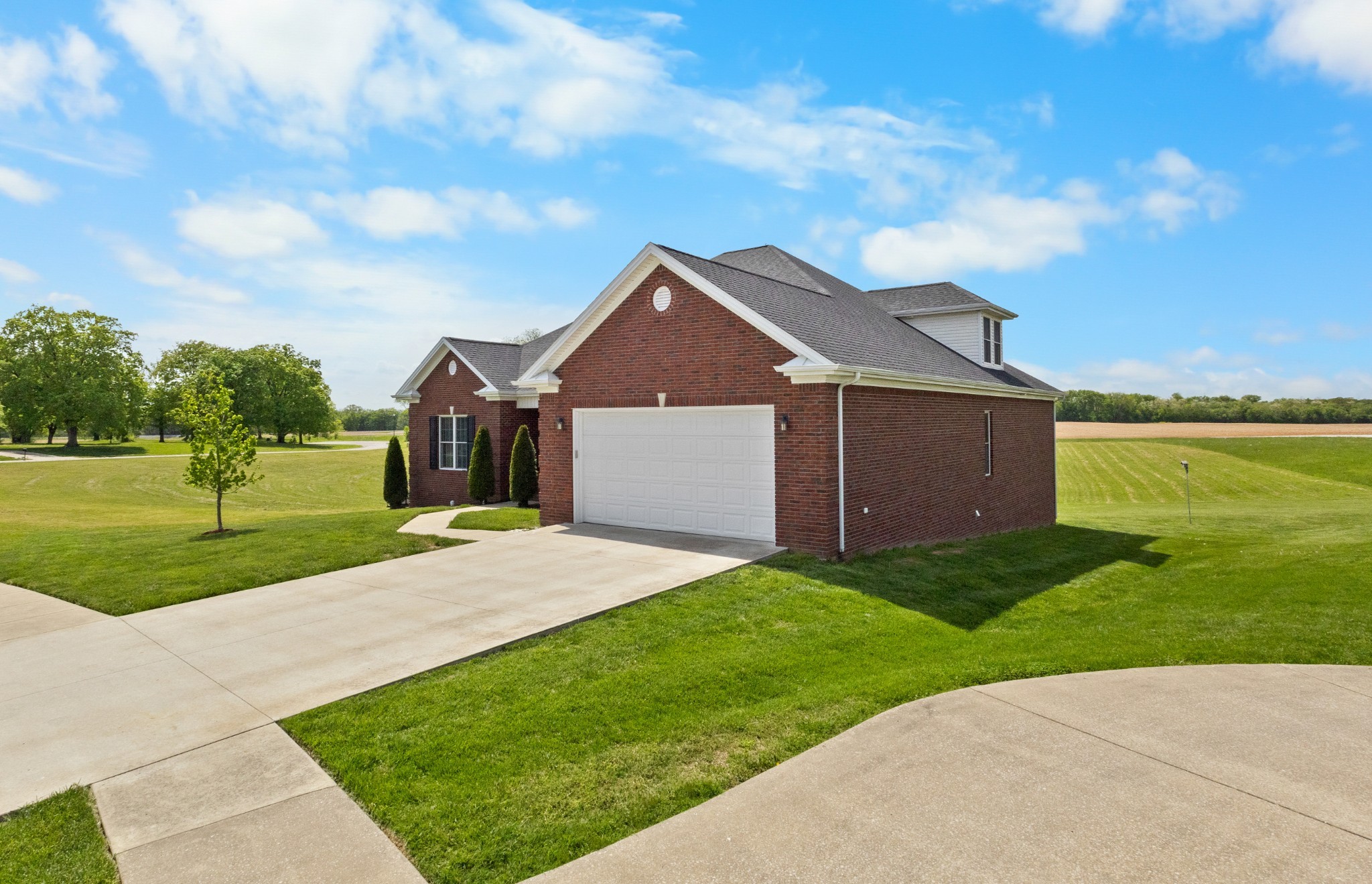 Gorgeous ALL-BRICK home featuring an open floorplan, formal dining room, 6 large bedrooms -all with walk in closets, and a HUGE bonus room! The master suite has a custom bathroom AND a custom closet, along with ample space for a reading nook, or seating area. You'll have all of the living space you need but you'll also have storage for everything else; with 2 walk-in attic spaces and an extra large basement space, that can double as a separate work or tinkering space! Enjoy your covered front porch or the all-season, partially covered back deck --the perfect spot to find your peace-of-mind, while looking out into beautiful pastures and the most breath-taking sunsets. ALL OF THIS on a CUL-DE-SAC, located 10 minutes (or less) from Ft. Campbell, shopping, restaurants, the Hopkinsville SportsPlex and the new Christian County High School!