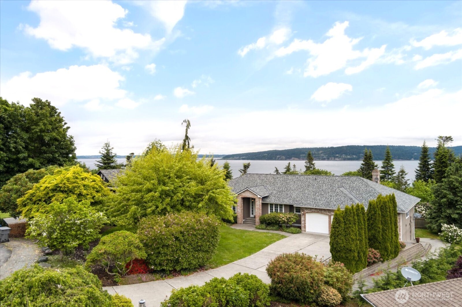 Stunning 3,274 sq ft Sound-view home on a .59-acre lot in Finisterre Heights. Light-filled with elegant entry, tall ceilings, statement making Italian tile flooring, and a massive deck to enjoy panoramic views of Puget Sound, Mt. Baker, and Whidbey Island. Features 3 bedrooms (including den), formal dining room, and a remodeled MIL suite in daylight basement with full kitchen and private entry. Chef’s kitchen with slab granite counters, skylight, and new appliances. Luxurious primary suite with marble bath and walk-in closet. New interior & exterior paint, 3-car garage, long driveway, fully fenced yard, and newer roof (2022). Easy bridge access—no ferry—plus nearby crabbing, boating, and fishing!
