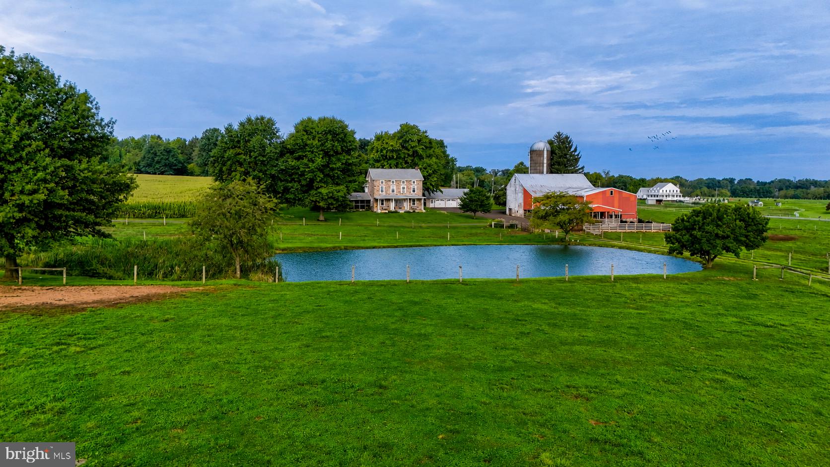 Welcome to 68 Seven Stars, a once in a lifetime opportunity to own a 58 acre rural estate in the heart of East Vincent Township. This property has it all, including an updated stone residence, beautiful bank barn, lush fields, and views overlooking the private pond. The dwelling has been thoughtfully updated throughout the years with custom kitchen, open dining, living room with fireplace, and charming wood floors throughout. The screened-in slate patio is the perfect place to relax, and the front covered porch offers views over the pond and rich farmland valley. The upper-levels include a bedroom suite with bath and walk-in closet, 3 additional bedrooms (1 semi-private), and an additional full bath. The grounds offer prime farmland with 50+ tillable acres and established fenced pasture. The bank barn is used for cattle and could easily be transformed to horse stalls, with the upper level having potential for storage or private event hosting! This farm was recently subdivided and includes 58 acres (see plan in documents). Farm is preserved with Chester County, and the existing building envelope is excluded for added flexibility. Adjoining land is also preserved, protecting the setting and views for generations to come! Within 30 minutes of King of Prussia and Malvern.