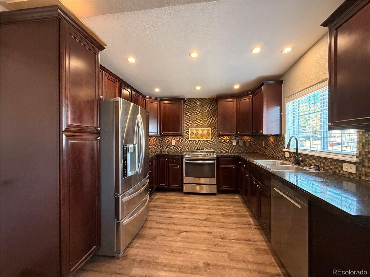 Big personality, thoughtful updates, and room for all the toys...this sparkling-clean Westwood home proves you don't need a huge house to live comfortably and have a whole lot of fun! Situated on an enormous corner lot, this unique and beautifully cared-for home offers an inviting open floor plan filled with graceful archways, warm finishes, and custom tilework throughout.The updated kitchen is ready for both everyday living and entertaining, with rich cabinetry, stainless steel appliances, generous counter space, and an oversized island where everyone will naturally gather. The home features three bedrooms and two full bathrooms, including a private primary suite with a walk-in closet and en suite bath.Outside, the large front patio is perfect for grilling, entertaining, or simply relaxing on a Colorado evening. Parking is almost an understatement here: there's a finished one-car garage, a gated driveway at the front, and additional concrete parking in back for an RV, boat, or other favorite toys. The fully privacy-fenced lot offers plenty of possibilities-and not a single blade of grass to mow! Bring your creativity, your patio furniture, and perhaps a few raised garden beds.Central air conditioning keeps things comfortable, while the convenient Westwood location puts you close to the Denver Public Library and an array of neighborhood eateries. Updated, distinctive, and clearly loved, this home has everything you need for a fun, comfortable, and wonderfully easy lifestyle.