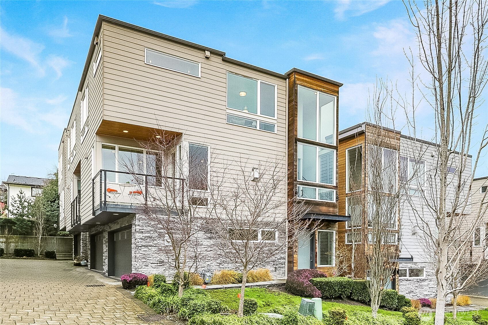 Sophisticated downtown Kirkland townhome in the sought-after City 12 community, offering refined, low-maintenance, lock-and-leave living in a premier location. Built in 2018 and meticulously maintained by the original owner, this 2-bedroom, 2.25-bath residence is filled with natural light on every level, giving the home a bright, polished feel throughout the day. The well-designed main living level features clean architectural lines and contemporary finishes, with a balcony off the kitchen—ideal for morning coffee or dining al fresco. Hunter Douglas motorized window blinds add everyday convenience and a refined aesthetic. The primary suite includes a well-appointed bath and generous closet space. Energy-efficient mini-split systems provide year-round comfort and flexibility. Attached two-car garage. HOA dues are notably competitive compared to other downtown Kirkland townhomes, supporting long-term value. Ideal for buyers who value efficiency, simplicity, and ease—whether commuting, traveling, or enjoying weekends away. Conveniently located near Kirkland Urban, the Google Campus, nearby beaches, dining, shopping, and the amenities of downtown Kirkland—an exceptional turnkey opportunity in one of the Eastside’s most competitive markets.
