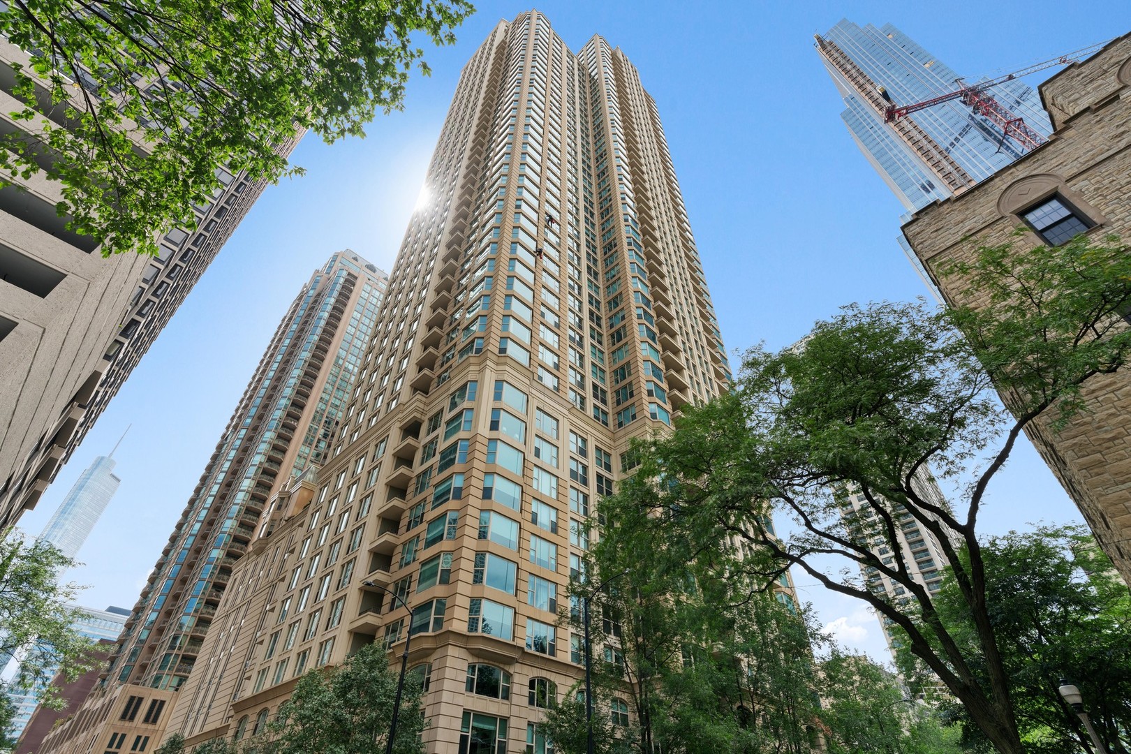Iconic and rare opportunity Penthouse available at The Fordham! PH #4302 offers a 3 bedroom converted to a classic and timeless build-out 2 bedroom plus den/library, 2.5 bath, south/west corner residence in one of Chicago's most prestigious luxury full service buildings. This refined home features custom millwork, redesigned areas including the foyer, den/library with wood panel bookcase and wet bar area. The gourmet chef's kitchen impresses with Sub Zero refrigeration, stainless steel Miel dishwasher, Wolfe range, drop-in stainless steel sink with goose neck "hot" faucet, custom light wood cabinetry with ample storage, granite countertops along with a generous island and enough auxiliary space for dining or "work from home", lastly a private balcony. The spacious combined living room and dining areas offers  sweeping 10" plus ceiling heights and centers around a custom gas fireplace and a dramatic bay window. Second bedroom en suite features custom outfitted closet, bath with stunning custom mosaic tile, tub and shower and ample storage. The primary bedroom en suite boasts a bath with separate soaking tub, shower, and a continuation of custom mosaic tiles. An additional private balcony located off in the primary suite with sweeping city vistas. Motorized window treatments throughout, wood flooring in primary areas and custom sound system. Unique to this penthouse offers a private 3-car garage with additional auxiliary storage in the building's garage extra cost at $199,000. A premium parking space on the main parking floor is included in the sales price. This home also features a laundry room with sink and additional storage. Please note, exclusive only to the three Penthouse owners exclusive ability to "lock off" private elevator operational services from the basement up to the 43rd floor!  Amenities at the Fordham include: 24 hour door staff, concierge, on site management and engineering team, heated indoor pool, spa and sauna, fitness center, sundeck, hospitality rooms, cigar lounge, and private screening room. All just steps from Michigan Avenue, Oak Street Beach and Chicago's ONE MAGNIFICENT MILE! Convenient access to major transportation and thoroughfares. Truly a must see, don't miss out!