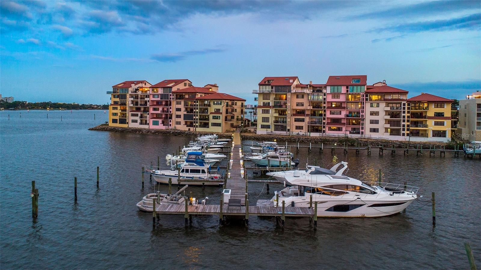 Buyers take note!   Major price reduction to a BELOW appraised price on this gorgeous property.  This impeccable property offers a lot of enticing amenities and is a fantastic price to be on the water in downtown Daytona Beach.  From shockingly low condo fees (based on the amenities provided, all you really need to do is pay a very low electric utility bill each month), to boat slips that are available for your boat, to a two-story penthouse unit, featuring a downstairs primary suite with an upstairs private guest suite, there is something for everyone here.  Go downstairs, board your boat, take your guests, and spend the day on the Intracoastal. Beautiful scenery, provocative views, intoxicating proximity to the water! There is nothing else like this listing. Every once in a while, a property comes along that is so elegant and well-done that it completely exceeds all expectations. This is one of those rare occasions where design meets proximity to the water, in this TWO-STORY penthouse location. This condominium unit has undergone a spectacular renovation that spanned several years, and it is now a complete showcase of elegance, style, and grace. Coined as 'nautical mediterranean' in concept, this is a stunning unit with unbelievable views and offering tremendous space and comfort. With several spacious bedrooms, you can use this as your winter home to escape the cold. Add to this the renovations the facility has undergone as a whole ($4 million in capital improvements to the roof, exterior structures, waterproofing, pool, parking areas, and more) and you will not have to do anything in Marina Point for decades to come. The seller has paid all existing assessments, and there is no work remaining for the buyer. Adorning the Halifax River and Intracoastal Waterway is this very spacious three-bedroom, three and one-half bath residence that features multiple outdoor terraces for dining and entertaining, as well as the full enjoyment of a private peninsula. You will be greeted by magnificent entry doors, beautiful, warm wooden floors throughout, wooden ceilings with beautiful beams, a fully renovated kitchen with expansive cabinet space, granite countertops, stainless steel preparation counters, quartz countertops, stainless steel appliances, and a custom window with amazing south-facing views of the Intracoastal. The kitchen has an eat-in area and is open to the main living and dining space with its floor-to-ceiling views of the Silver Beach Bridge and all the way up the Intracoastal, which is a sight to behold at night. You can step onto the large outdoor terrace (which also features a custom picture window into the living room for additional light) where you can enjoy dinner and cocktails under a serene breeze and watch the boats going by. Watching the Christmas Boat Parade from here is a truly magical experience. This terrace is large enough for entertaining all of your guests in front of the outdoor fireplace, while you dine and watch the sunset. There is a half bathroom for guests and for convenience and entertaining There are three large bedrooms, each with a dedicated, extensively renovated full bathroom, an in-unit laundry room with plenty of space for folding and for storage, and several large closets within every bedroom. The primary suite also features floor to ceiling windows with a direct view of the Halifax River/Intracoastal Waterway.