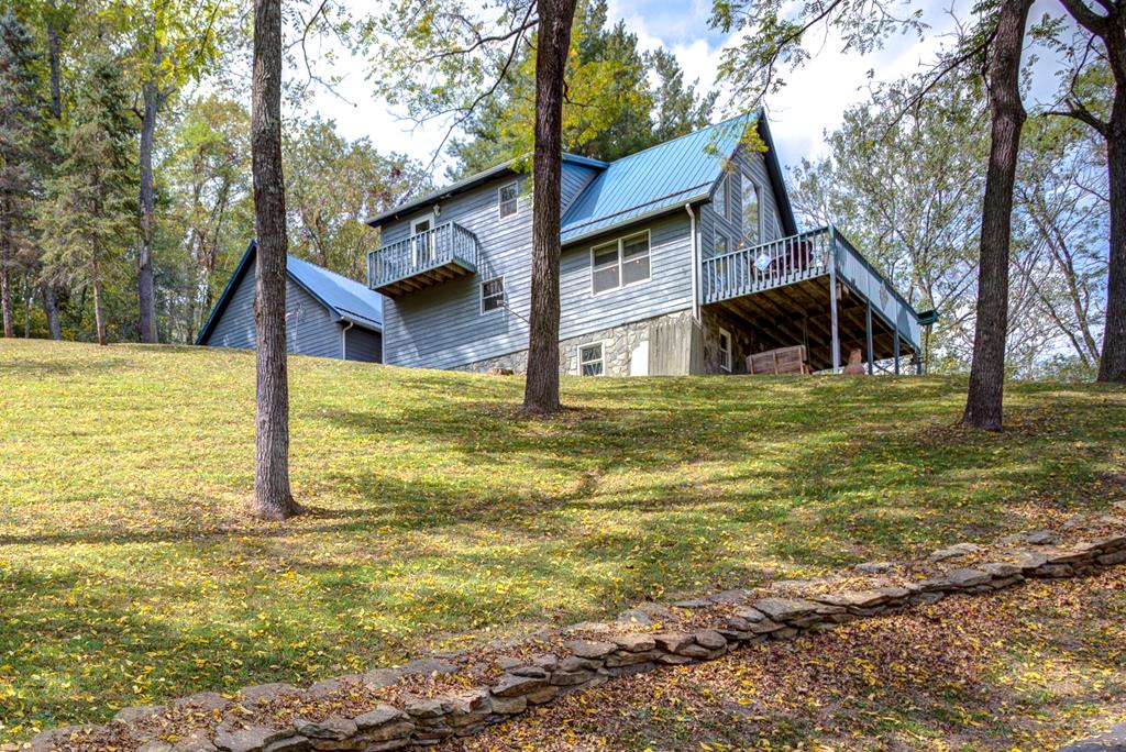 Tranquility at it's finest. Tucked away in the Blue Ridge Mountains of Southwest, VA is a quaint Mountain Home on 2.428 ac+/- overlooking the New River and surrounding Mountains. Home features open Kitchen/Living/Dining with Beamed Vaulted Ceiling and grooved hardwood floors, Oak Cabinets, 1BR/1BA on main floor, Primary BR/BA on second floor with a balcony, Oversized Bedroom over the 2 Car Garage, Basement Laundry/Workshop/game room, and one Car basement Garage. There's a Generac Whole house Generator, Paved driveway and rock retaining walls. Homes comes fully furnished including the Kayak's. This is one of a Kind home located in the Coxs Chapel Community of Grayson County Virginia. Mountain living at it's finest. Take a look today!