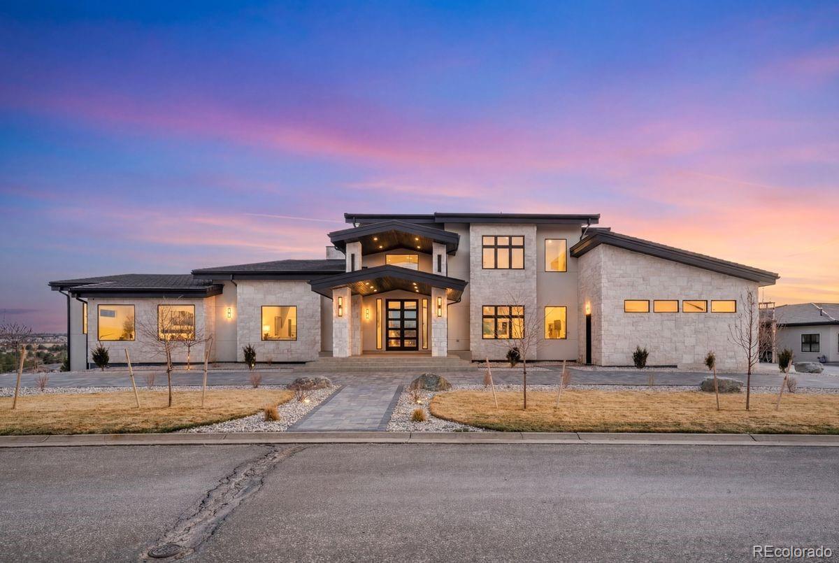 Includes an en-suite bedroom or office with ¾ bath and walk-in closet, elegant powder bath, mudroom with pantry/storage, and a 5-car garage. The primary suite is a true retreat with dual bathrooms, heated floors, oversized soaking tub, walk-in closet, fireplace, and private balcony overlooking the basketball court. The grand living room offers soaring ceilings, fireplace, and dual sliding doors to the patio. The gourmet kitchen features a double island, built-in storage, natural light, and direct outdoor access. Wet bar and custom storage room included.Walk-out basement built for entertaining with fireplace, spacious living area, private bedroom suite, office, theater room with powder bath, laundry, and dog wash station. The gym connects to an indoor basketball court and features a spa-like bath with sauna and steam shower. Includes bar area, balcony, and direct backyard access. Outdoor highlights include a fire pit, golf cart garage, and locker room with multiple showers and baths. Upstairs, multiple bedroom suites with walk-in closets and en-suite baths, including a private suite with fireplace. Upstairs laundry, powder bath, and deck access complete the level. Recessed lighting throughout the home.