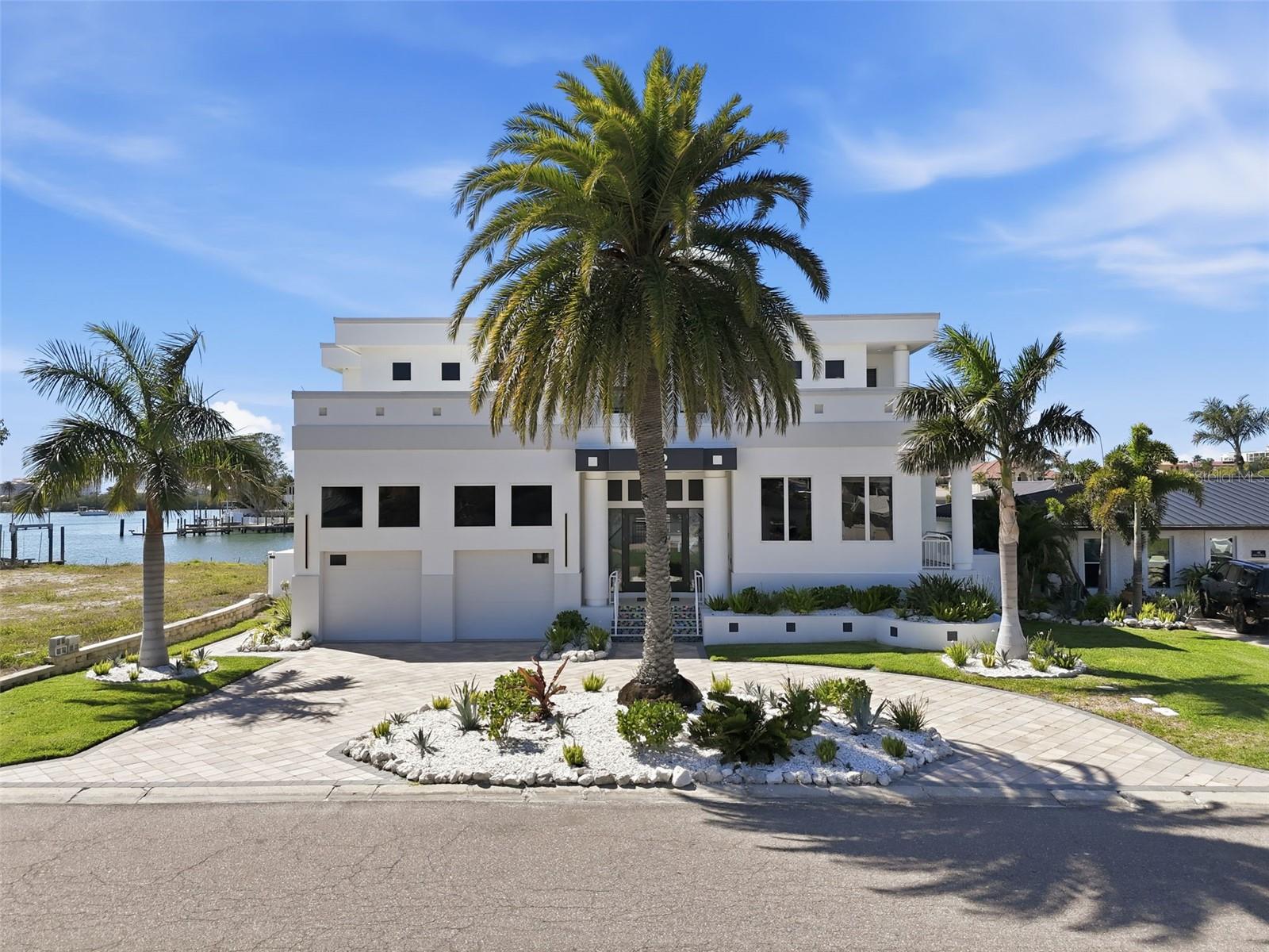 Not every waterfront home is built the same—some are simply placed on the water. Others are designed to live with it.Welcome to 42 Midway, where luxury, privacy, and true coastal living come together in one of Clearwater Beach’s most sought-after waterfront communities, Island Estates.This 4-bedroom, 3.5-bath residence offers nearly 5,000 square feet of thoughtfully designed space, where walls of glass frame sweeping water views and natural light pours into every corner. The layout flows effortlessly, creating the perfect balance between refined entertaining and relaxed everyday living.At the center of the home, the chef’s kitchen is both functional and impressive—featuring high-end appliances, custom cabinetry, and a seamless connection to the main living areas so you’re always part of the moment.Upstairs and down, the home continues to deliver—spacious bedrooms, elevated finishes, and water views that never get old.Step outside and the experience shifts from impressive to unforgettable. Your private outdoor retreat features a resort-style pool and spa, lush tropical landscaping, and a fully equipped outdoor kitchen built for hosting. Just beyond, your private dock and boat lift provide direct Gulf access—turning spontaneous sunset cruises into a daily option, not a special occasion.Homes like this don’t just offer features—they offer a lifestyle. Quiet mornings on the water, afternoons on the boat, and evenings entertaining under the Florida sky.If you’ve been waiting for a Clearwater Beach waterfront home that truly delivers on location, design, and livability—this is the one worth seeing.