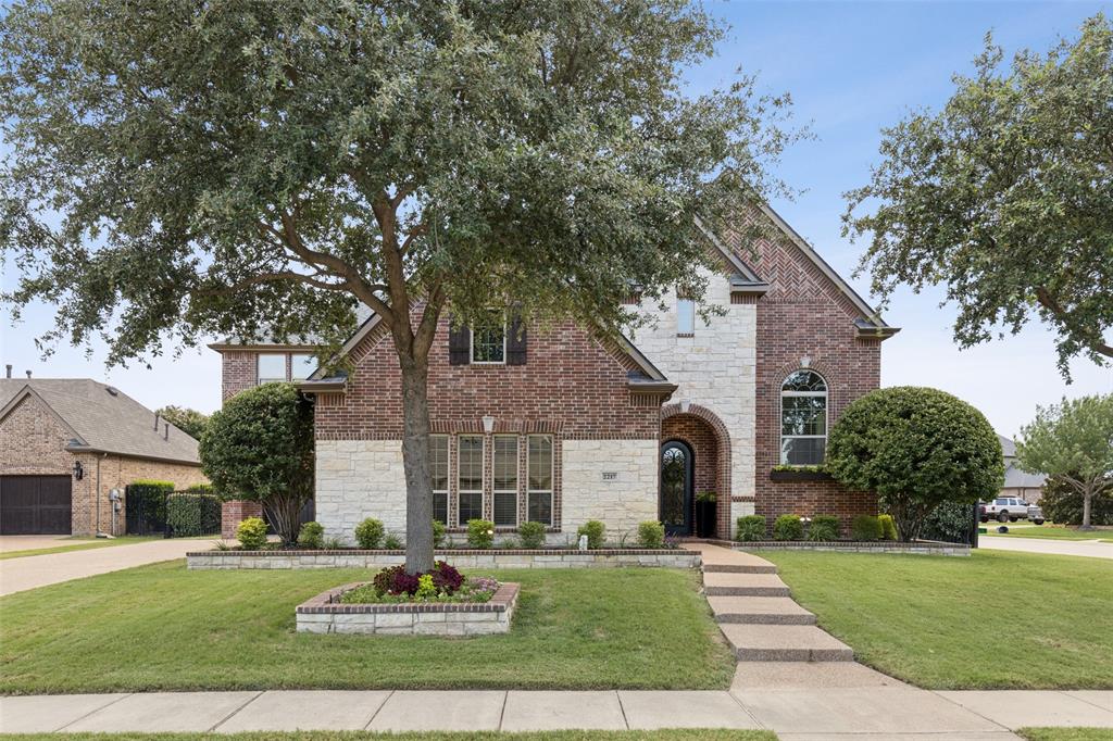Located in the sought-after Turnberry addition of The Highlands at Trophy Club, this beautifully updated transitional 5-bedroom home offers 5,079 square feet of move-in ready living space on an oversized corner lot with impressive curb appeal. From the elegant arched iron entry door to the rich hand-scraped hardwood floors and designer lighting throughout, every detail has been thoughtfully curated. A curved staircase anchors the grand foyer, while the elevated open office or formal living room offers flexibility. The spacious formal dining room is ideal for entertaining and flows into a stunning chef’s kitchen featuring an oversized island, quartz countertops, custom tilework, stainless steel appliances, commercial-grade vent hood, and double ovens. The light-filled breakfast area with built-in cabinetry opens to the large living room with a sleek floor-to-ceiling tile fireplace and expansive views of the private backyard oasis. Outside, enjoy a sparkling pool and spa with tanning ledge, built-in umbrella, large covered patio, mature landscaping for privacy, and a flat grassy area perfect for kids and pets. The oversized primary suite is a true retreat with a sitting area, built-in fireplace, pool views, and spa-inspired bath with dual vanities, jetted tub, frameless glass shower, and large walk-in closet. Upstairs, enjoy a spacious loft, separate media room, elevated game room with wet bar and balcony with sunset views, four additional bedrooms, and three full baths -one being an en-suite bath. With dual staircases, abundant storage, and a well-equipped laundry room with sink and space for a second fridge, this home truly checks every box. All located just 15 minutes from DFW Airport in a golf cart-friendly community with pool, splash pad, tennis, pickleball, trails, dog park, and golf with membership, and award winning Northwest ISD. *New Roof and Gutters*New pool pump*