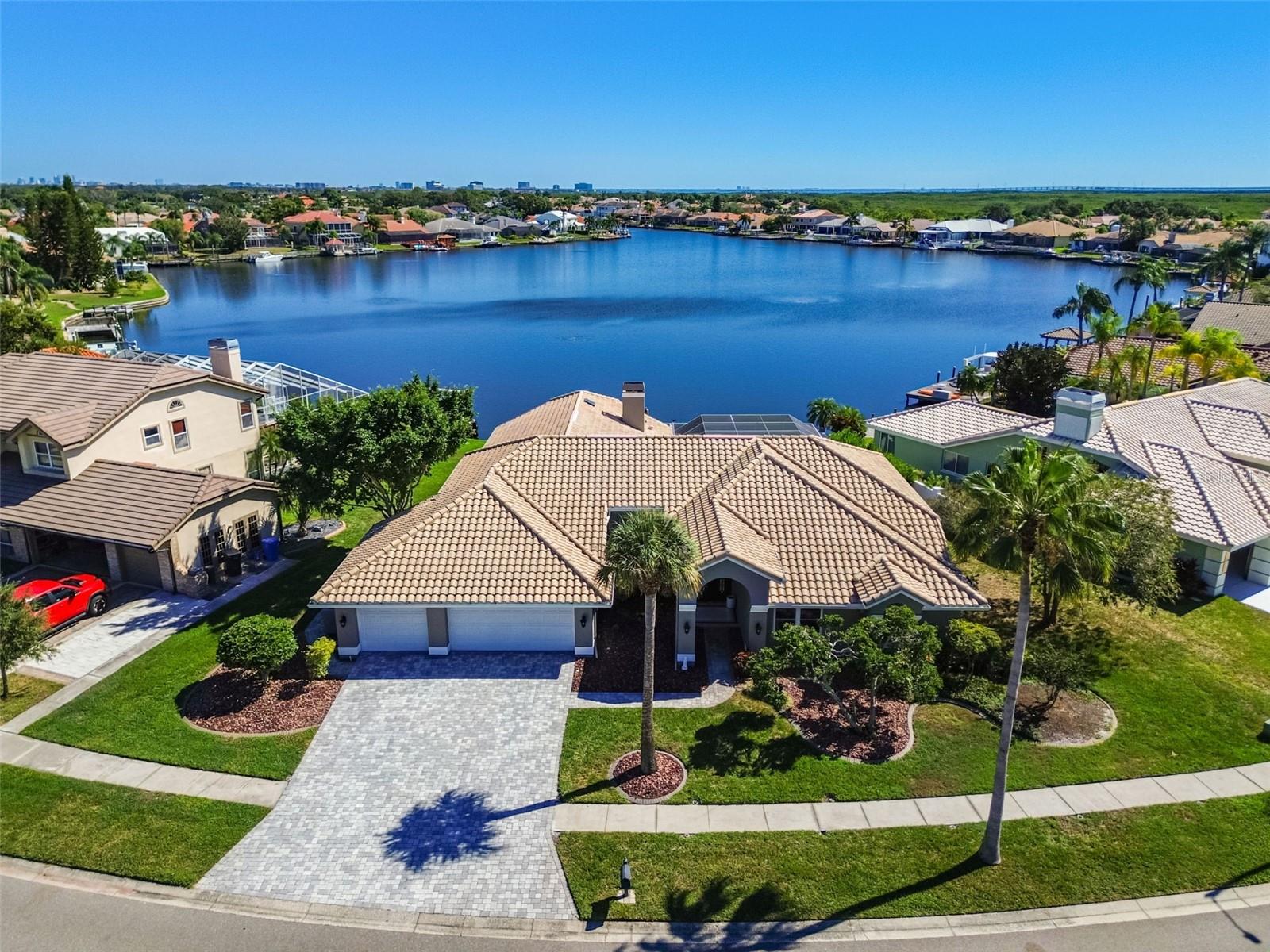 Step into refined coastal elegance with this fully remodeled single-story estate in the gated Bayside community, offering direct Gulf access from your private dock and boat lift. A grand paver driveway and three-car garage welcome you to over 3,300 square feet of water views and light-filled living spaces designed for both style and comfort. Inside, new luxury vinyl plank flooring, plantation shutters, and motorized smart blinds enhance the open layout. The chef’s kitchen is a true centerpiece with an oversized island, stone countertops, stainless steel appliances, new gas cooktop and dishwasher, and designer backsplash, seamlessly flowing into formal living and dining spaces and a spacious family room featuring a redesigned fireplace accent wall. The primary suite offers patio access, a spa-inspired bath with dual vanities, soaking tub, walk-in shower, custom closet, and an additional dedicated water heater. The guest suite provides privacy at the rear of the home, while two additional bedrooms share a beautifully updated bath. Every detail has been elevated with thoughtful upgrades, including newly remodeled master and guest baths, new gutters, interior and exterior paint, two Trane HVAC systems, a hybrid water heater, and pool updates with new pumps, super gutters, and a rescreened enclosure. Outside, enjoy a screened-in pool and spa, outdoor kitchen, and expansive paver patio ideal for entertaining by the water. With direct boating access to Tampa Bay and the Gulf, this home perfectly blends sophistication, functionality, and the best of waterfront living. While offering a spectacular location just minutes from top-rated schools, premier dining, Tampa International Airport, downtown, and the beaches! Make your appointment today!