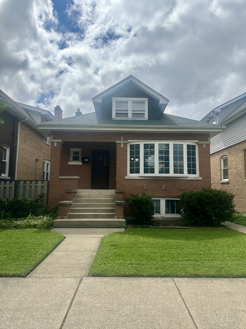 For safety reasons the water and gas are off and should not be turned on. Welcome to this very large 5-bedroom 3-bathroom brick bungalow that is in need of your ideas and repair. The large bay window in the front of the home allows for lots of natural light and the classic hardwood floors, rich wood doors and 2 kitchens give you an idea of the home's potential!  There is also a large garage which means no need to look for parking spots. This is a great opportunity if you are an investor looking for your next project or a homeowner looking to renovate your dream home. Property is an estate sale and being sold As-Is.