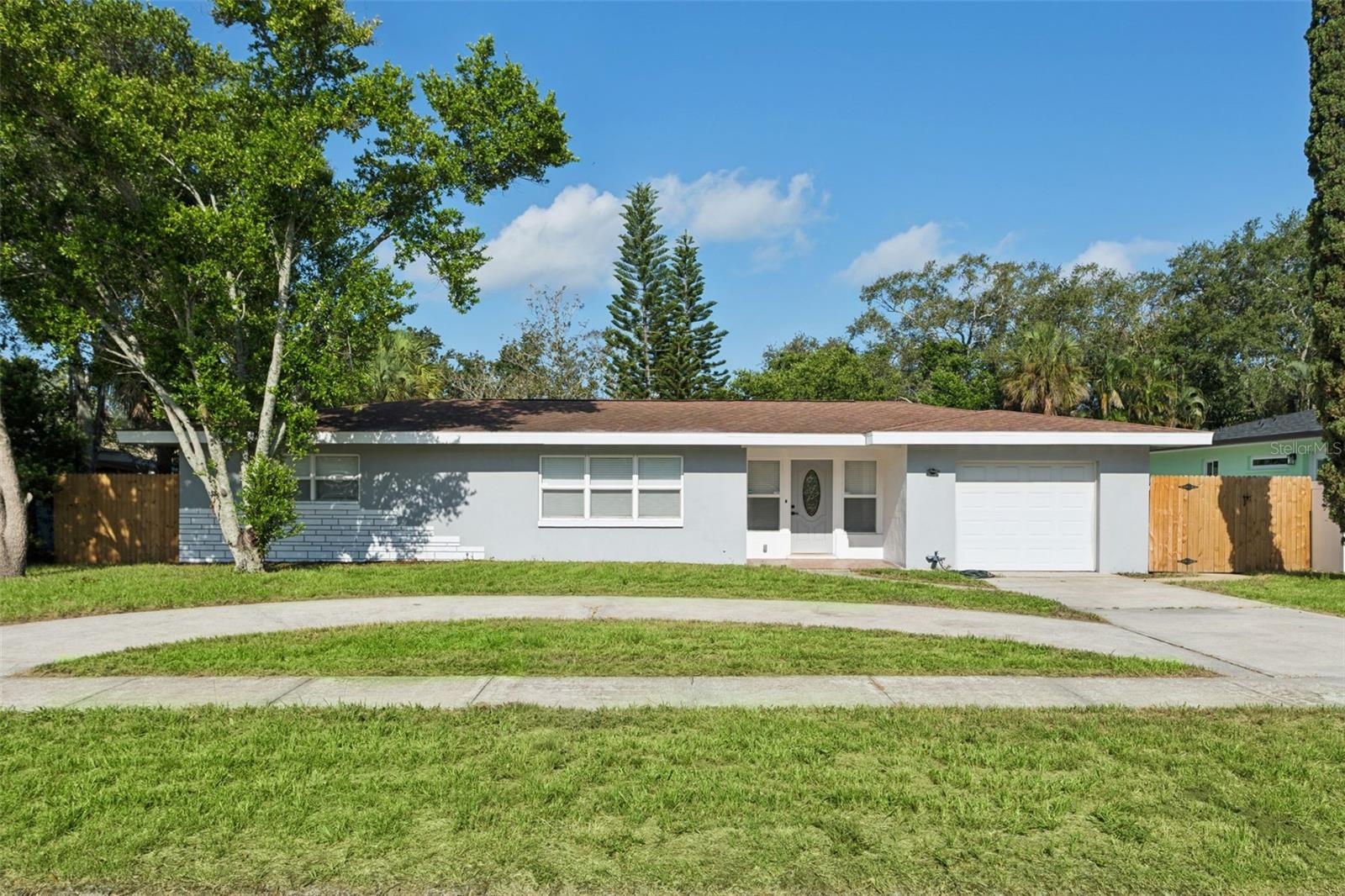 Look at this totally remodeled home just a couple blocks walk to the Dunedin village center.  Evening walks to restaurants and local shops is so nice and relaxing on a cool afternoon.  Two bedrooms and two bathrooms, a large living room connected to the kitchen, and a separate dining room, make this a very usable and comfortable floor plan.  The kitchen has all new upgraded appliances, and a totally renovated and updated layout.  Designed for a natural and easy workflow when meal prep is happening.  Other thoughtful improvements include a tankless water heater, heated and lighted bathroom mirrors, USB combo outlets in the bedrooms for charging at night, and a full modern bathroom in the garage made ready for an extra living space or flex room.  The seller can convert this space after the sale if needed.  This backyard has so many possibilities, its huge and has been newly fenced, great for dogs or keeping little ones contained.  The listing has been virtually staged to help with planning your new home layout.