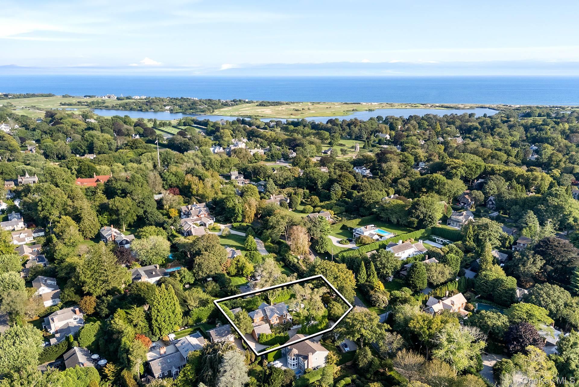 This elegant East Hampton Village home (circa 1870) underwent a gut renovation in 2023 under the acute eyes of architect Mark Zeff. Today, the home provides all modern amenities with special touches from years gone by. The large front porch welcomes you, the foyer offers a beautiful staircase with period detailing. Next is a spacious living room with original details and a fireplace, an enclosed sunroom overlooking the grounds offers a peaceful retreat. The gourmet kitchen is a chef's dream. A first-floor primary en-suite with walk through closet. On the second floor is another en-suite and three additional guest rooms with a full bathroom. The finished lower level offers additional spaces like a full bath, TV room, and office space. The heated gunite 13 x 40 pool is located next to a 13 x 7 spa overlooking the garden and pool house. Amenities include central air and beautifully finished pool house. Conveniently located close to the village restaurants and stores. Also, 1.26 miles to Main Beach.