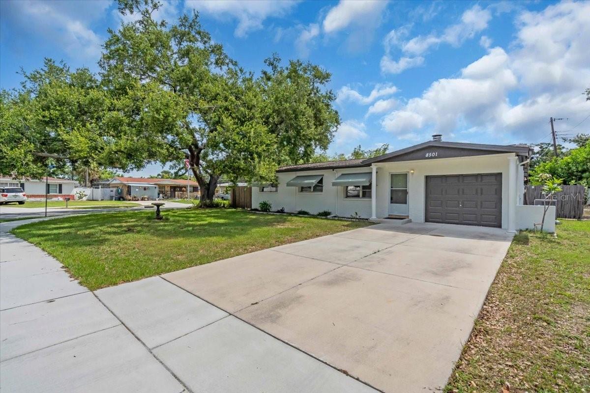 Under contract-accepting backup offers. This centrally located Pinellas Park home boasts an open floor plan with a spacious great room featuring a wood-burning fireplace. The completely renovated kitchen offers ample cabinets, new stainless-steel appliances, and abundant granite counter space. There is a dining area and an island with a breakfast bar. Additional living space can be found in the good-sized family room, which leads to a screened porch and the backyard. The home has three bedrooms at the front and an additional bedroom at the back, perfect for a home office. The master bedroom includes an updated half bath with new tile and fixtures. The hall bath features a tub with shower and a large vanity.  Many updates including new AC (2025) and roof (2018).  Attached 1 car garage with new double driveway.  Situated on a large corner lot, the fully fenced yard provides privacy and space.  Close to tons of shopping, the best Gulf beaches, schools,  and more!