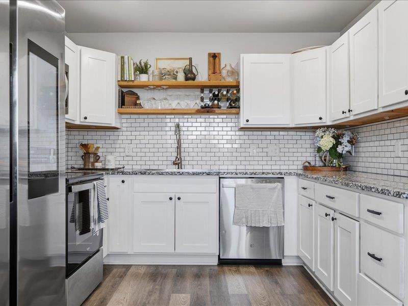 Completely renovated and move-in ready, this stunning 3 bed, 2 bath home in Moore has been taken down to the studs and rebuilt with quality and style throughout. Nearly everything is new, including HVAC, roof (with rafters and decking), electrical panel and wiring, hot water tank, and windows. Inside, you’re welcomed by a striking vintage wood-burning fireplace with a custom cedar mantle that adds warmth and character. The kitchen features new cabinetry, granite countertops, stylish backsplash, a large stainless steel sink, and all-new stainless steel appliances—plus a bonus pantry for extra storage. The home offers an oversized laundry room with plenty of space, along with a versatile bonus area perfect for a home office or playroom. The primary bathroom has been fully updated with a new shower, vanity, toilet, and fixtures. Additional updates include waterproof LVP flooring throughout, carpet in two bedrooms, and fresh interior and exterior paint. Enjoy the covered back patio overlooking a spacious backyard—perfect for relaxing or entertaining. A true must-see!