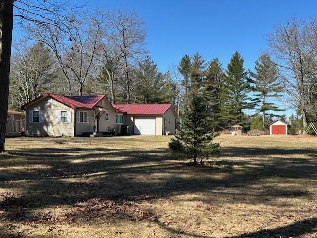 The sign says, "TAWAS POINTE IN THE WOODS"!!! Welcome to a UNIQUE property that offers something for everyone to enjoy! The UP-North cottage or year round home has recently been remodeled and offers comfort, for you and your guests! The property itself offers 3 different lots on Baldwin Resort Road, plus it backs up to 23 additional private acres for your walking & hunting pleasure! These spacious grounds leave you with options for potential further development should you decide you would like to put up a couple more homes OR keep it just AS-IS and keep the elbow room for yourself! The current home has been tastefully redone and boasts a large living space with gas log fireplace, great natural lighting with oversized windows and tongue and groove pine ceilings. The kitchen offers plenty of Hickory cabinets, a copper sink, appliances are included. There are 3 bedrooms, 2 baths, a stack washer & dryer in utility room. Neutral paint on the walls and fresh floorings through-out! There is an attached garage, plus a large storage shed! This property is truly like a retreat! A manageable greenhouse is included, there is a sauna for relaxing and all kinds of room to put up a volleyball net, throw a football or just gather around a campfire! Conveniently located just a short distance from downtown East Tawas, Lake Huron, public beaches, Tawas Point State Park and so much more!