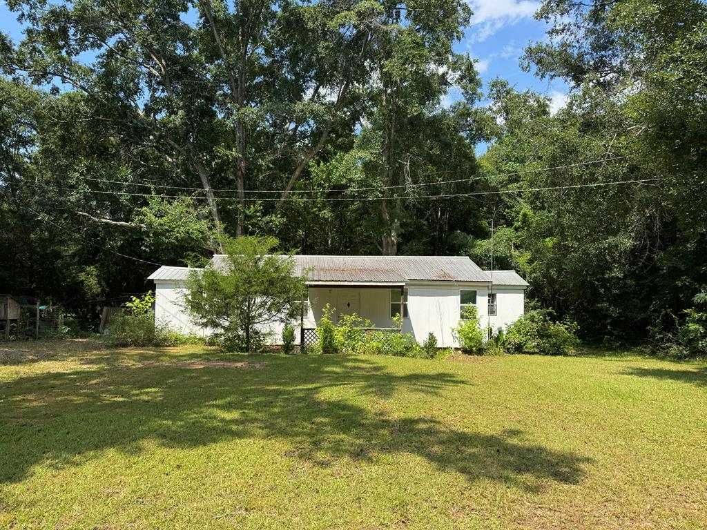 Harris County investment FIXER-UPPER sold AS IS, Originally a single-wide mobile home that has been added onto over the years.  One 1/3 acre with large oaks. Covered back porch, metal roof, several replacement windows added. Two/three bedrooms, one bath, laundry roof. small workshop/barn with shed.