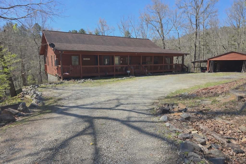 Welcome to your private retreat on 5.67 beautiful acres—where comfort, functionality, and country charm come together seamlessly. This thoughtfully designed home offers incredible versatility, featuring a newly finished upstairs and a spacious layout perfect for modern living. Inside, you'll find two cozy fireplaces, a dedicated gym room, and a secure safe room for added peace of mind. The home also offers a partially enclosed back porch—ideal for enjoying the serene surroundings year-round. The finished lower level provides a second living space complete with a full kitchen, making it perfect for multi-generational living, guests, or even potential rental income. Outdoors, the property is truly exceptional. Equestrian-ready, the land includes a creek, barn with stalls, hay storage, and a tack room. Additional features include a carport, two tool sheds, and a separate entrance to a portion of the property—offering the potential for a second home site. This property can be subdivided.  Located in a lightly restricted neighborhood, this property offers the freedom to enjoy country living without sacrificing convenience. A rare opportunity to own a versatile estate with space, privacy, and endless possibilities!