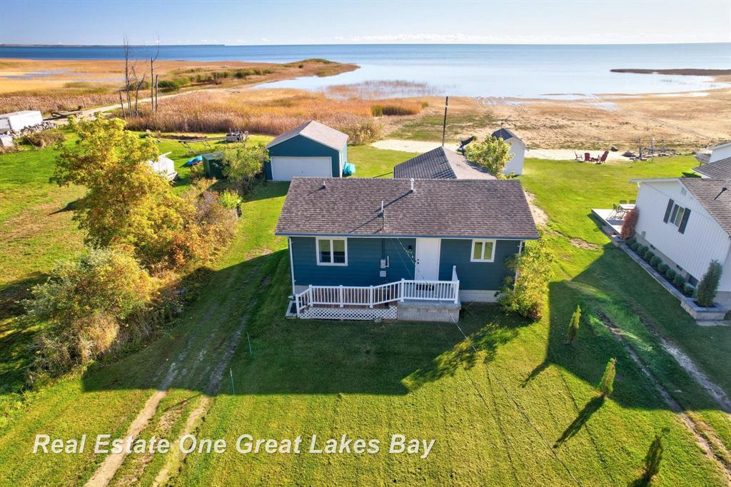 Beautiful Lakefront on Beachwood!!!  Charming two-bedroom, one bath ht as been beautifully updated throughout. Features Hickory Kitchen Cabinetry with Granite counter tops. Newer Furnace and Hot Water Heater.  Space Saver Washer and Dryer. Water softener. 3 New Window A/C units.  Perfectly positioned to capture stunning sunrise over the water.  Great View of Pt AuGres!!  Includes a two-car garage, plenty of potential to make it your own slice of Paradise. Great Fishing, kayaking. Minutes from Saganing Eagle Casino. Close to AuGres, Tawas, and West Branch. Ideal year around home or a weekend getaway.  Able to hook to Natural Gas at road. Must See This Gem!!!!