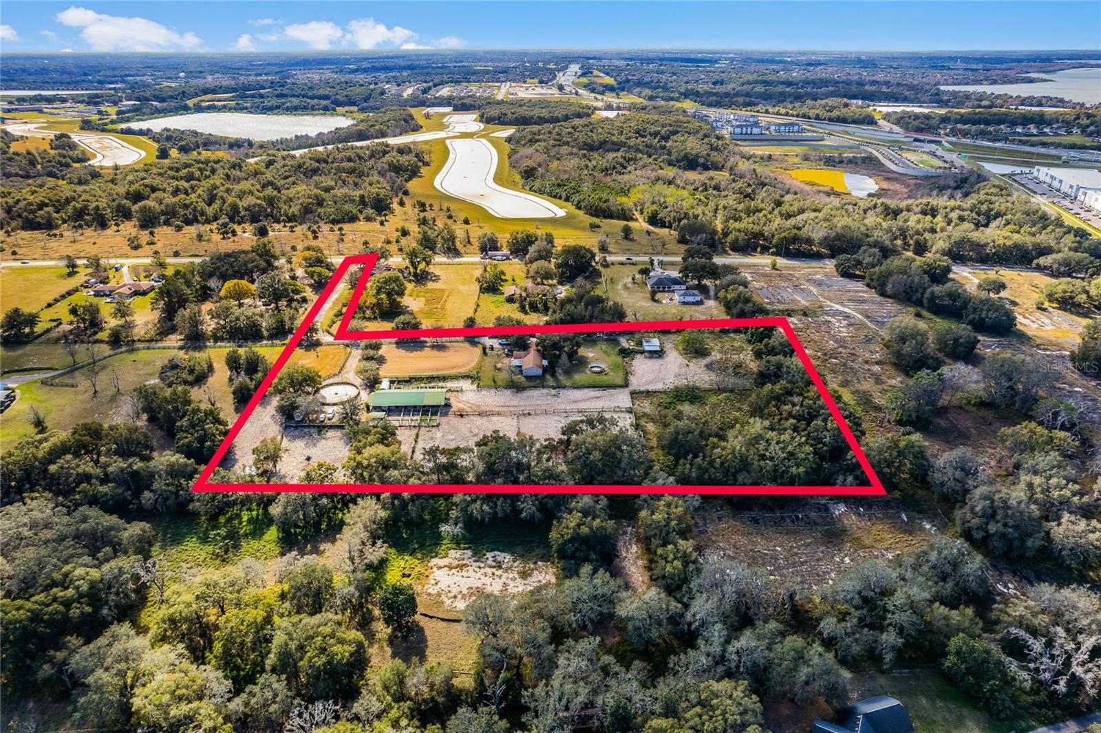 Under contract-accepting backup offers. This secluded single family residence provides privacy and plenty of space to enjoy the outdoors. A great opportunity to own 8 acres of property in Apopka! Currently a full working horse farm! This amazing property has an 11 stall barn, each stall with its own paddock, indoor and outdoor wash racks, a barn office with a full bathroom, a tack room and hay room, a lighted arena and lighted round pen, and 8 fenced pastures with poll barns. This property is complete with a 4 bedroom 2 bathroom modular home too! So many upgrades to this home, like stainless steel appliances, solid wood cabinets and granite counter tops and even a newer roof! A beautiful front screened porch is perfect for those cosy mornings having coffee while watching the horses graze. The possibilities of this property are truly endless! Invest in a private getaway, and invest in a prime piece of real estate in a growing area of Apopka. This is an excellent investment! Prime location, close to major shopping, medical, schools, restaurants, and recreational facilities. What more could you ask for!!