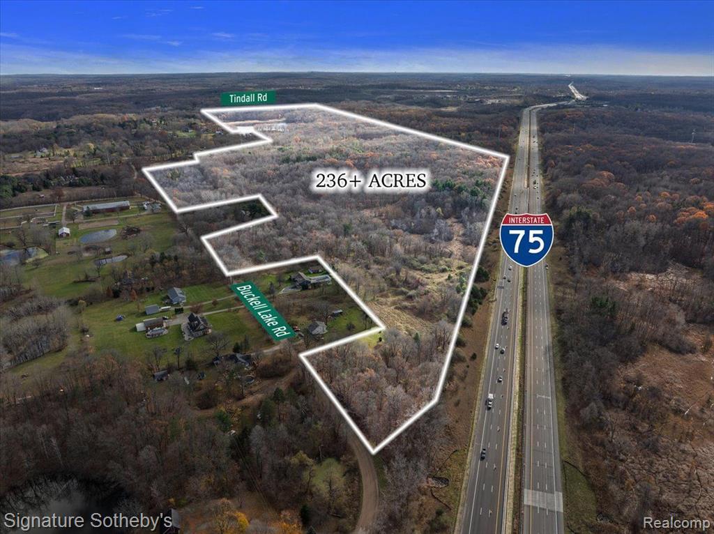 With over 36 acres of magnificent wooded land right before your eyes, this remarkable property is perched on 6 sprawling parcels, offering a canvas for a variety of visions.  From creating a luxurious family estate to the development of an upscale residential community.  Whether envisioning a serene retreat, sprawling custom home development, senior housing community or data center possibilities- this property is ideal for anyone.  The expansive property boasts over 1 mile of frontage on I-75 and easy access to freeway ramps.  Paved road frontage on Tindall Road, Buckell Lake Rd and I-75.  The picturesque property features gravel driveway, extensive equestrian trails and is currently wired for data.  With a beautiful country setting and two spring-fed lakes on the property, fishing and hunting abound.  Just 20 minutes from downtown Birmingham and 40 minutes from downtown Detroit this property is absolutely one of a kind.  With larger parcels becoming increasingly scarce, it’s time to grab this property before its too late.