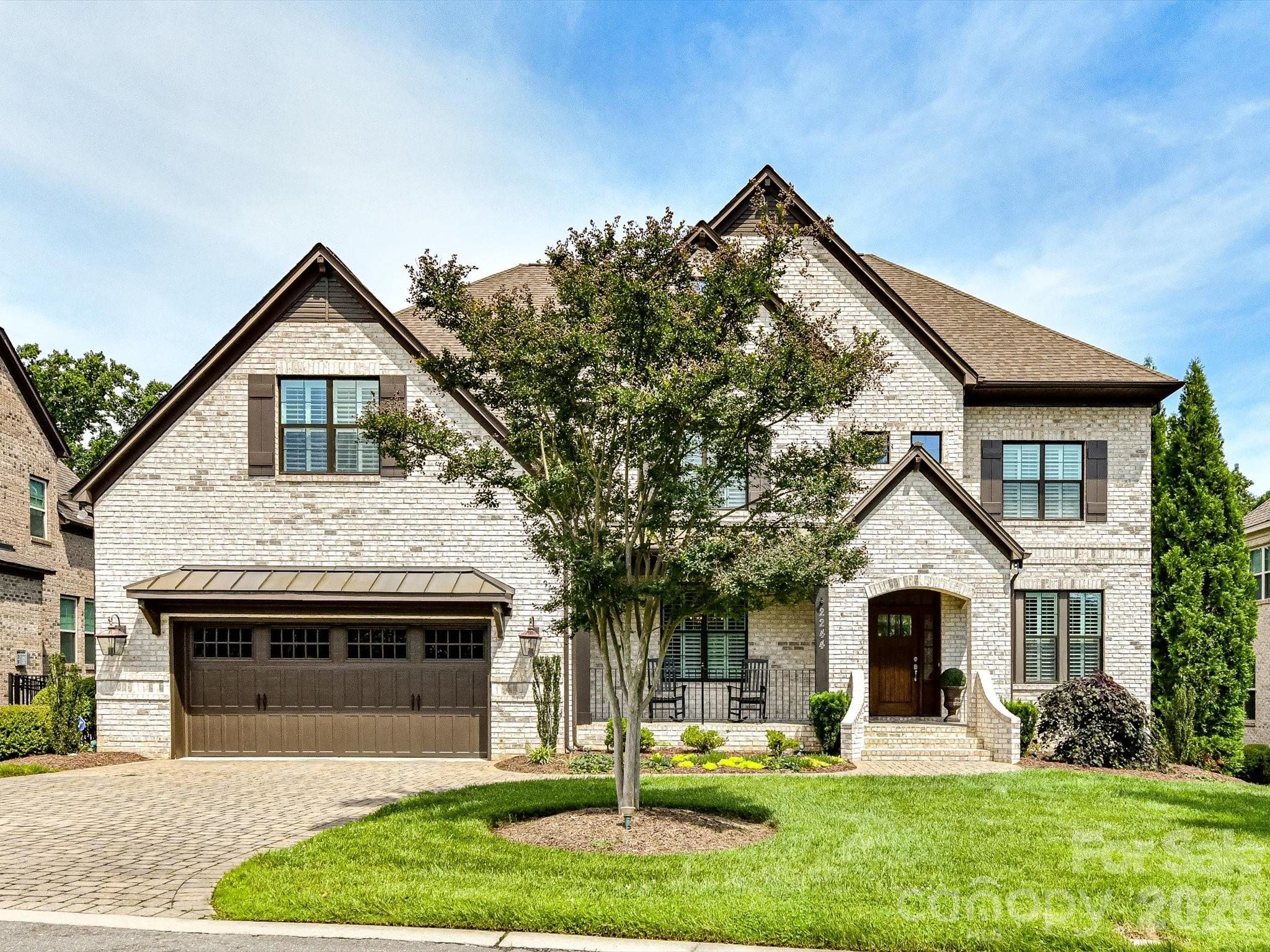 Refined living in the heart of SouthPark. Nestled in the Songwood Estates community, this elegant home combines classic design with effortless, low-maintenance living. The two-story foyer welcomes you into light-filled interiors featuring newly refinished hardwood floors, a private office with French doors, and a gracious dining room ideal for entertaining. The chef's kitchen showcases granite countertops, white cabinetry, premium KitchenAid appliances, and a sunny breakfast area overlooking the beautifully landscaped backyard. Enjoy seamless indoor-outdoor living on the covered deck or paver patio, backing to mature trees that provide exceptional privacy.Upstairs, the expansive primary suite offers a private sitting area, spa-inspired bath, and custom walk-in closet. Each secondary bedroom features fresh neutral finishes and its own en-suite bath, while the spacious bonus room provides the perfect setting for media, recreation, or relaxation. With HOA-maintained front and rear landscaping and convenient access to SouthPark's premier shopping, dining, parks, and greenways, this home delivers luxury, comfort, and convenience in one exceptional property.