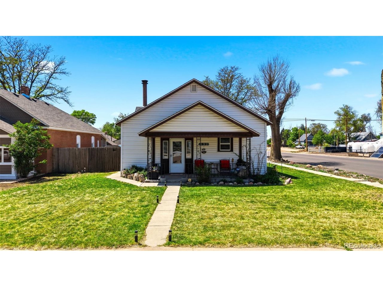 Showings Start Sat 5/16! This thoughtfully updated 4-bedroom, 2-bathroom, single-story home offers 1,510 finished SF with a covered front porch on a spacious corner lot in the heart of Eaton. Bonus: no HOA! Originally built in 1900 and remodeled throughout, this home leads with rich original hardwood floors, soaring ceilings, and a stunning brick wood-burning stove that anchors the open living and dining space. The updated kitchen features white cabinetry, stainless appliances, and tile flooring. Both bathrooms have been refreshed - the full bath showcases a quartz countertop with dark wood cabinetry. In-unit washer and dryer included. The primary bedroom is generously sized with multiple closets. Three additional bedrooms offer flexible space for a home office, guest room, or hobby room. Outside, enjoy a large private fenced backyard with raised garden beds, storage shed, and patio - ideal for entertaining or gardening under Colorado's sunny skies. The oversized detached 576 SF 2-car garage plus 2 additional off-street spaces provide exceptional parking. The drone views showcase Eaton's beloved small-town charm, with it's tree-lined streets, agricultural landscape, and walkable access to downtown shops and dining just blocks away. This is Eaton living at its finest. Come see this home today!