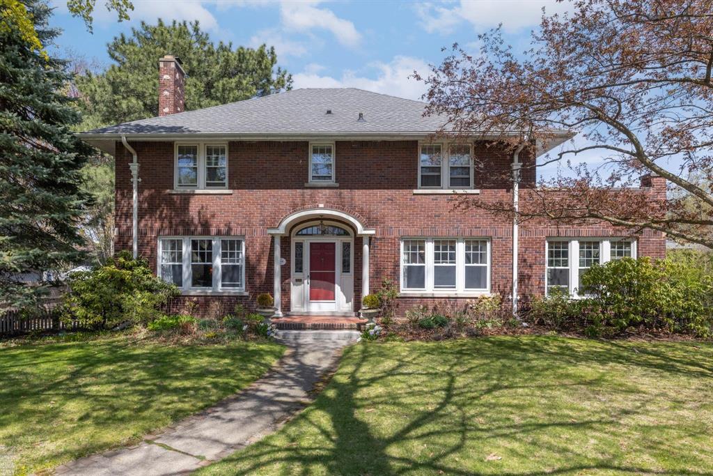 Built in 1925 for the Beaupre family and cherished by just 3 other owners since, this stately Colonial is a rare find where architectural charm and thoughtful updates live in perfect harmony. From the moment you arrive, you will feel the history, and the love, that have graced this home for a century. Original millwork, leaded glass, and rich hardwood floors honor the past, while a brand-new kitchen speaks to the future with its high-end finishes, designer fixtures, and seamless function. Whether you are hosting a holiday gathering or enjoying a quiet evening in, the first-floor layout flows effortlessly. With 5 generously sized bedrooms and enviable closet space throughout, there is room for everyone (and everything). A sun-soaked home office, cozy family room, mudroom, and a living room anchored by a gas fireplace check all the boxes for today's lifestyle and the unbeatable walkability rounds out the long list of amenities. Come for the charm. Stay for the feeling. Welcome home.