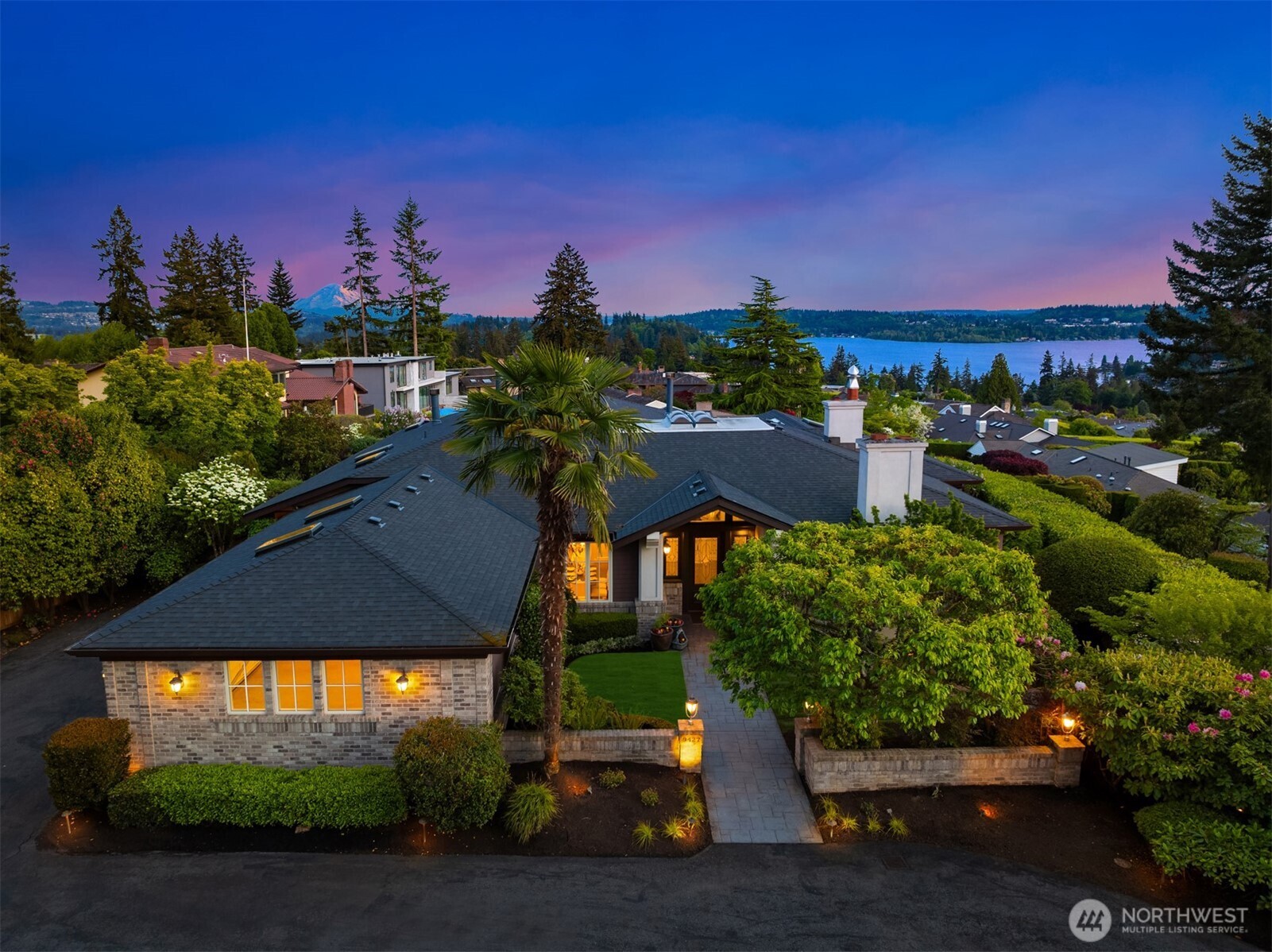 Perched above it all in the heart of Clyde Hill, this rare offering commands panoramic views of Lake Washington, the Seattle skyline, Mt. Rainier, and the Olympic Mountains. Sited on a private half-acre lot, the home features an expansive covered outdoor terrace to enjoy the beauty of the PNW year-round. Designed for seamless living on one level, the main floor hosts a spacious primary suite, sunroom, elegant office, laundry, family room, formal living, and dining rooms—all positioned to maximize light and views. Downstairs, find a large recreation room, second primary suite, two additional bedrooms, craft room, wine cellar, and abundant storage. A rare opportunity, located in one of Washington’s most coveted neighborhoods.