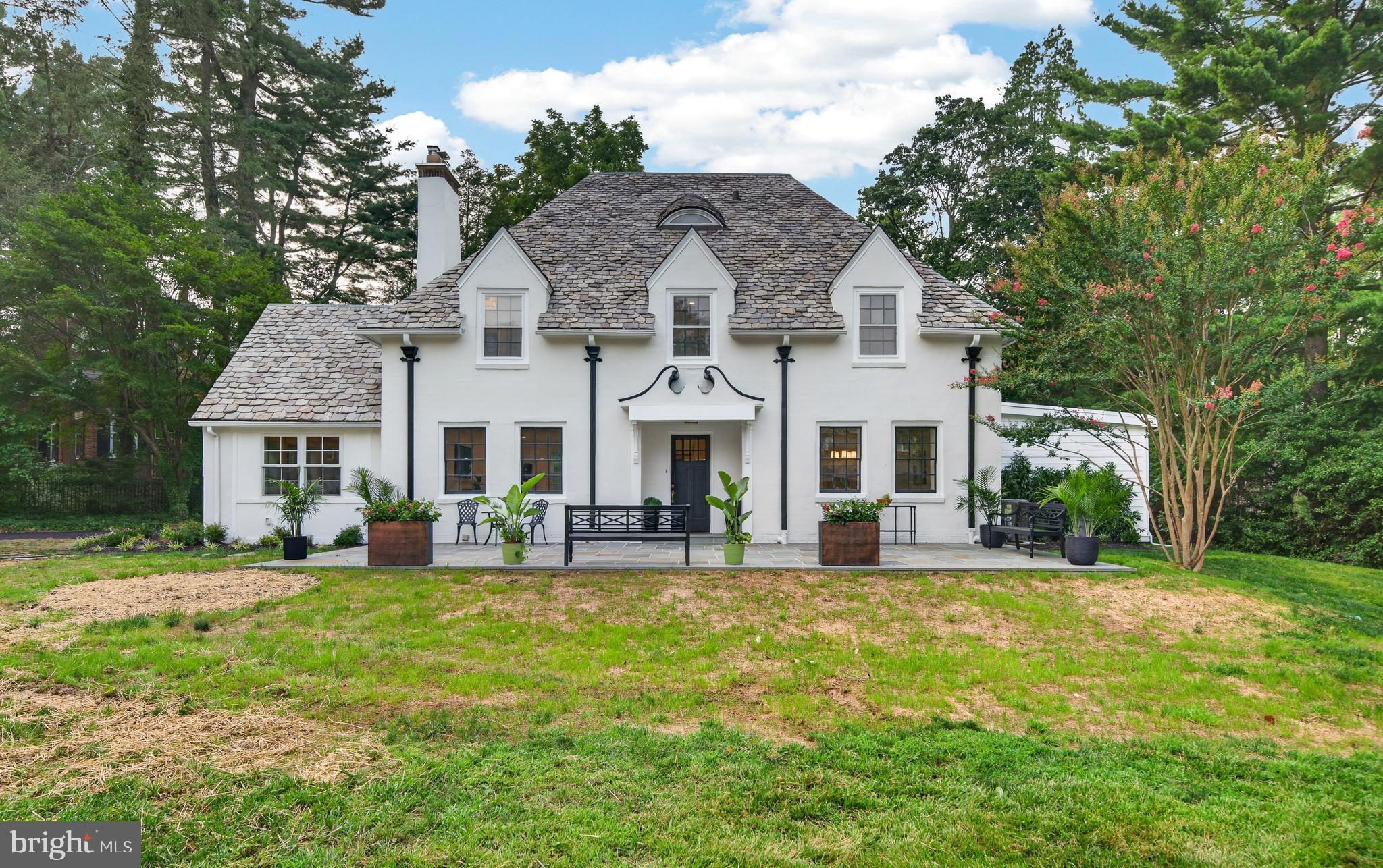Welcome to this enchanting English country cottage, where timeless charm meets the comforts of modern living. Thoughtfully updated while preserving its old-world character, this exceptional home showcases gorgeous hardwood floors throughout the first and second levels, a graceful turned staircase, and an abundance of architectural details that create a warm and inviting atmosphere.Step inside to discover a light-filled home office with a vaulted ceiling, providing the perfect space to work or relax. The spacious family room is centered around a cozy wood-burning fireplace, while the elegant formal dining room is designed for memorable gatherings and features a delightful hidden storage area tucked within the custom wainscoting—a charming nod to the home's character.The heart of the home is the stunning, open-concept kitchen, beautifully appointed with KraftMaid cabinetry, a large center island, premium Thermador appliances including a custom built-in refrigerator, a six-burner gas range with a custom-designed hood, and abundant workspace for everyday living and entertaining. The adjoining breakfast area offers a built-in banquette beneath a picturesque window, creating the perfect spot for morning coffee or casual meals. Just beyond the kitchen, a door opens to the inviting rear patio and beautifully private backyard, seamlessly blending indoor and outdoor living.Practicality meets style in the well-designed mudroom, complete with extensive built-in storage and convenient interior access to the attached two-car garage. A first-floor laundry room and powder room add everyday convenience.Upstairs, the luxurious primary suite serves as a peaceful retreat, featuring a spacious walk-in closet and a beautifully appointed ensuite bath with dual vanities, a walk-in shower, and exquisite custom tile work. Three additional bedrooms complete the second floor. Two bedrooms share a thoughtfully designed Jack-and-Jill bathroom, while the fourth bedroom enjoys the privacy of its own ensuite bath.The third floor features an additional bedroom with a full bath and a bonus room, that could additionally be a second home office, play room, or home gym.With its perfect balance of classic English cottage charm and today's most desirable amenities, this truly special home offers warmth, elegance, and exceptional spaces for both everyday living and unforgettable entertaining.