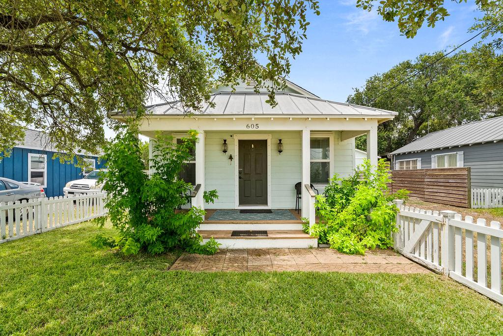 This darling South Rockport coastal cottage just got even better with a gorgeous new pool and stunning outdoor kitchen area that take this beachy bungalow to a whole new level of charm and function. Nestled just blocks from downtown shops, restaurants, and the Aransas Bay, this fully fenced 2-bed, 2-bath home offers an open-concept layout, updated finishes, and a spacious backyard perfect for entertaining. French doors off the primary suite open to a shaded deck, now overlooking your own private oasis, complete with a resort-style pool, patio, and custom grilling station. Whether you're seeking a full-time residence, a weekend retreat, or a high-performing short-term rental investment, this turnkey gem delivers. No HOA, and furnishings included!