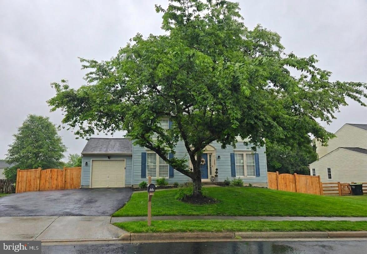 Located in sought-after Belmont Ridge, this beautifully updated single-family detached home offers 3 bedrooms, 2.5 baths, a 1-car garage, and a large fenced rear yard tucked away on a quiet cul-de-sac street in Belmont Ridge.  The main level features formal living and dining rooms accented with chair railing and crown molding, creating a warm and elegant first impression. The gourmet kitchen offers granite countertops, stainless steel appliances, a center island, updated cabinetry, and abundant storage space, with direct access to the expansive updated deck — perfect for grilling, outdoor dining, or entertaining guests. The cozy wood-burning fireplace with mantle adds charm and comfort for chilly evenings.Upstairs, the spacious primary suite features vaulted ceilings, abundant natural light, a large walk-in closet, and an attached private bath. Two additional generously sized bedrooms, a linen closet, and a full bath with tile flooring and tub/shower combination complete the upper level.The unfinished basement includes a rough-in for a future full bathroom and walkout access to the beautifully fenced backyard, offering endless potential for additional living space, recreation, or a home gym.Extensive recent updates and upgrades include:New 6-foot wood privacy fence (2023)Expanded driveway for 2-car parking (2023)Updated patio deck (2023)Luxury vinyl flooring installed throughout with all carpet removed (2023)Updated kitchen cabinetry (2023)New interior light fixtures and ceiling fans (2023)Recessed lighting in kitchen (2023) Zebra blinds installed throughout, including a smart center blind with remote, app control, and solar charging capability (2023)Interior stairs updated and freshly painted (2023)New Ecobee smart thermostat with remote sensors (2023)New toilets, bathroom vanities, sinks, and lighting (2023)New washer and dryer (2023)Updated front yard landscaping with hydrangeas (2023)Exterior light fixtures with built-in Blink security cameras (2023)Updated garage and WiFi-enabled garage door opener (2025)New refrigerator (2025)New HVAC steel vent covers (2025)Roof replaced in 2017 with warranty documentation availableMove-in ready and meticulously maintained, this exceptional home offers stylish upgrades, smart technology, functional living spaces, and an ideal location close to shopping, dining, commuter routes, parks, and community amenities.