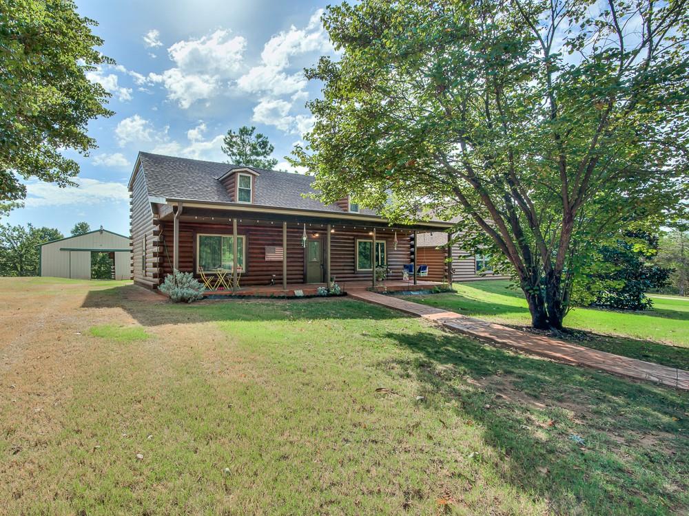 Log Home on 5.01 MOL acres, 3 bed 2 1/2 baths 3 car garage. Built in 2001 has a circle drive, property is fenced with wire and cross fenced for the animals.  Has above ground pool with deck for a place to cool off on these hot summer days.  Lots of wildlife, property is shaded with mature trees.  Wood burn fireplace in the living area. Loft upstairs could be an office/work space/bonus area. Storm shelter in the yard.  Shop building/barn for all the extras you might have.  Welcome home and start making some memories.