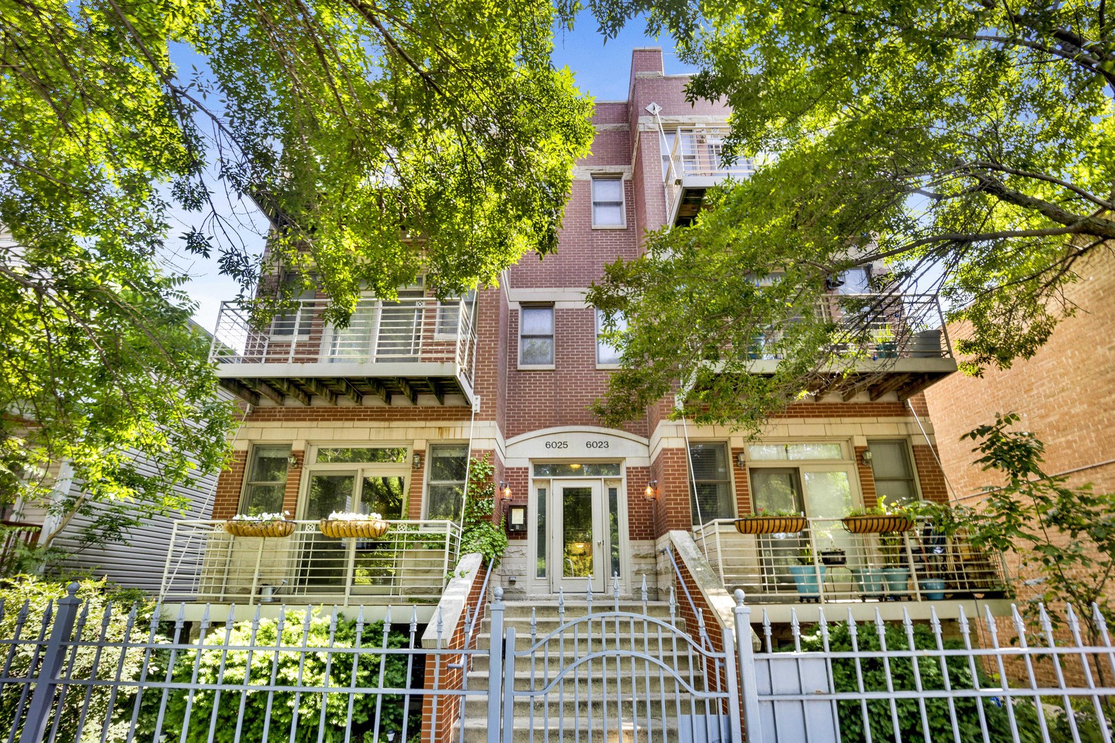 Welcome to this expansive 3-bedroom, 3-bath duplex that lives like a single-family home and is just two blocks from the gateway to Andersonville. With two private outdoor spaces-including a front balcony and rear deck-this home is perfect for both relaxing and entertaining. The open-concept main level features soaring ceilings, recessed lighting, freshly painted walls, and newly refinished hardwood floors. The kitchen is equipped with 42-inch cabinets, granite countertops, an island, and stainless steel appliances. Adjacent to the kitchen, the living and dining area offers a cozy gas/wood-burning fireplace and sliding glass doors leading to the balcony. The oversized primary suite boasts a walk-in closet, private deck access, and an en-suite bath with a whirlpool tub. The lower level includes a large family room with a second fireplace, an additional bedroom and full bath-ideal for guests or a home office-a full laundry room, and abundant storage. Additional features include tandem parking for two cars and a separate storage unit. Just steps from the Red Line, Clark Street bus stop, and the new Metra station-this is urban living at its best.