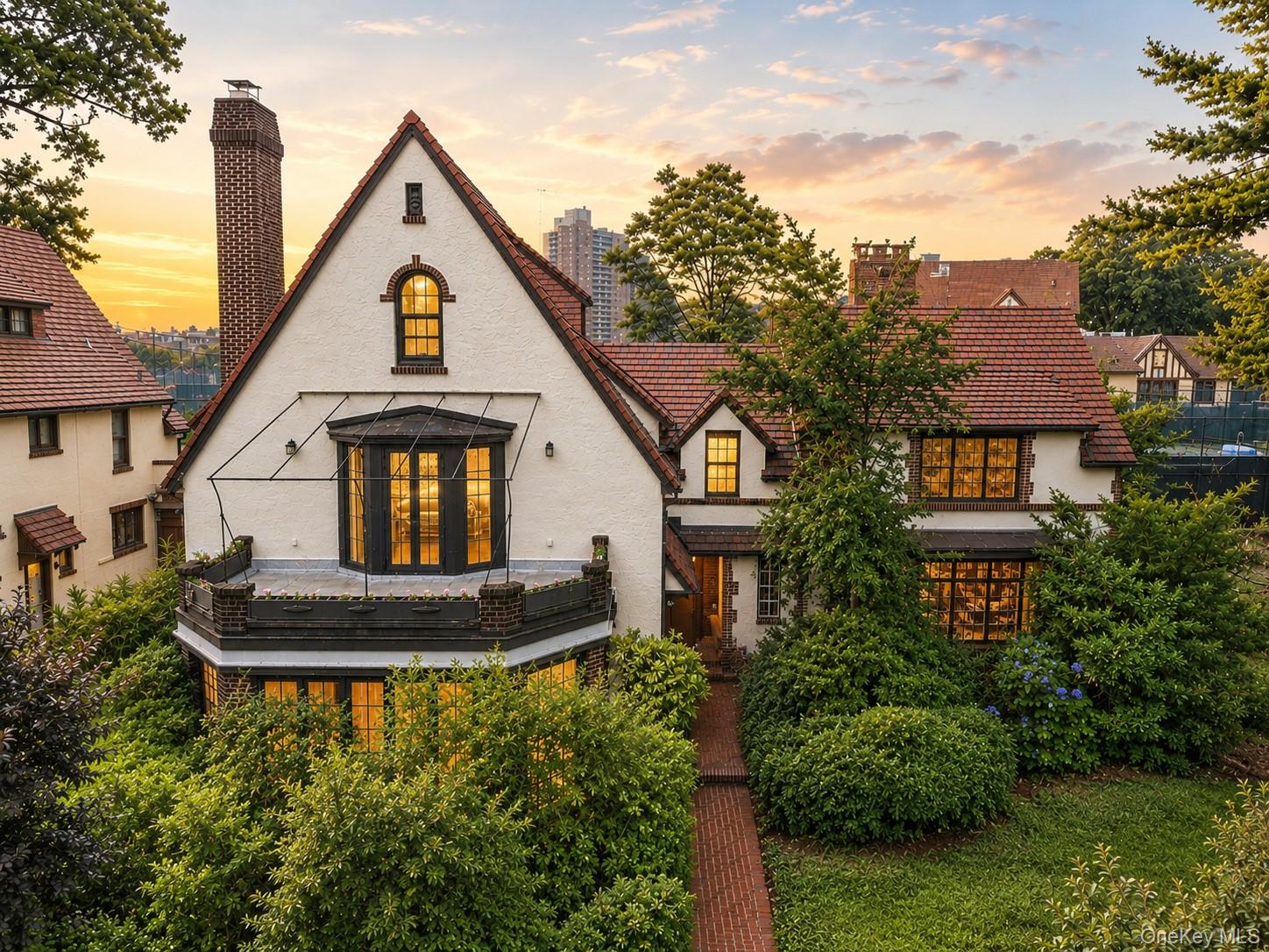 We are pleased to present this charming home nestled on one of Forest Hills Gardens' most coveted streets. Built in 1925 and set on a generous quarter-acre lot, this stately brick and stucco home offers six Bedrooms, six full Bathrooms, and one half Bath across 4,693 interior square feet of gracious living space. Enter through a cozy foyer that flows seamlessly to a spacious living room anchored by a large stone fireplace and featuring a bright, open sunroom with floor-to-ceiling bay windows. A formal dining room with warm hardwood floors and classic tilework framed by a large dry bar equipped with a sink and wine refrigerator provide the perfect backdrop for cozy meals and hosting gatherings alike. The adjacent spacious kitchen with direct backyard access and ornate living area complete the main level. The expansive lot is among the largest on Dartmouth Street, and affords lush outdoor space perfectly suited for gardening, play, or entertaining in a private, park-like setting. This remarkable home is located on a tree-lined street mere blocks from Forest Hills Station Square, Austin Street, the LIRR, and the E, F, M, and R subway lines, making it exceptionally convenient to reach New York City. Find close by restaurants, boutique shops, charming cafés, the many amenities of Forest Park, and the prestigious West Side Tennis Club. Step inside this rare Forest Hills Gardens treasure and make it your dream retreat from the city’s bustle!