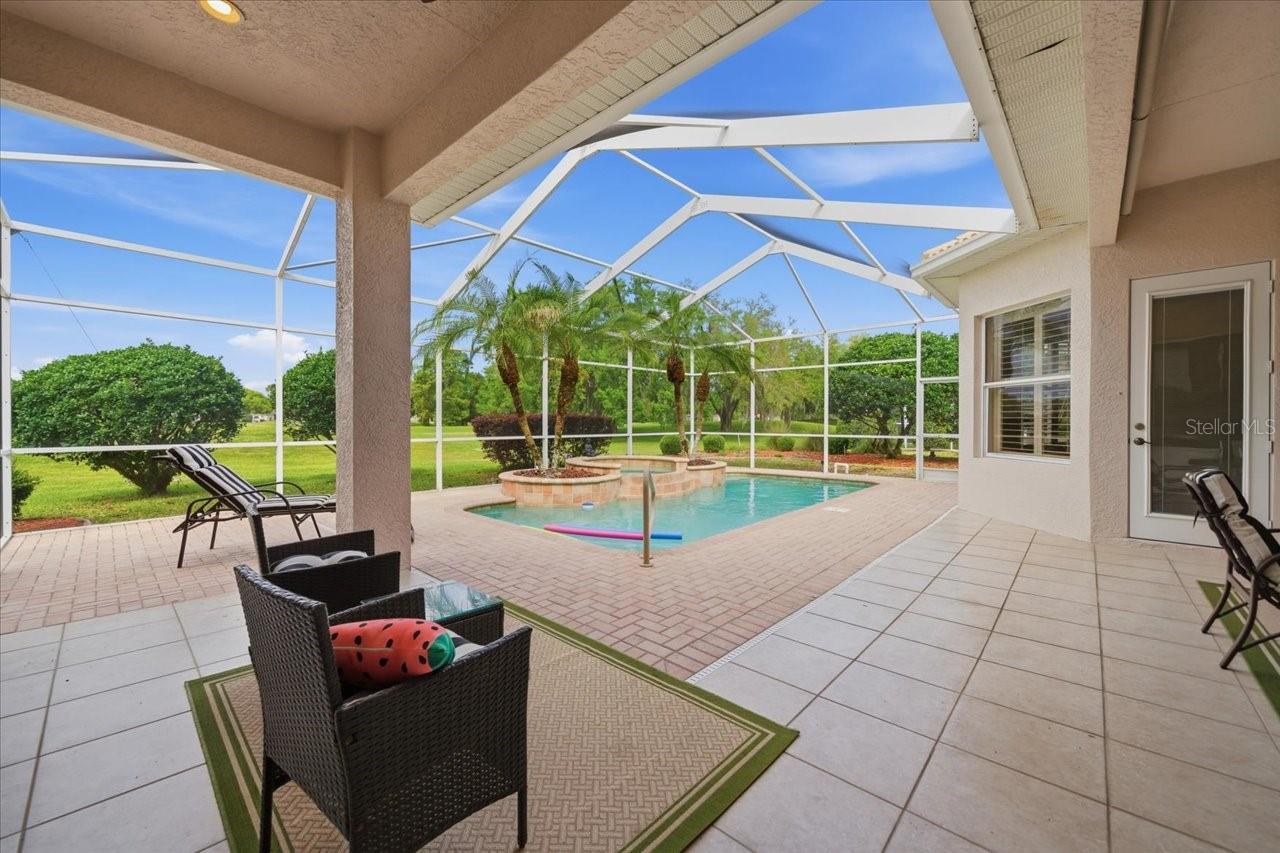 If you’ve been looking for a GOLF COURSE HOME, this one right here is worth a look. Sitting right on the 18TH HOLE in Silverthorn, this 5 BEDROOM, 4 BATH home gives you BEAUTIFUL SUNSET VIEWS straight over your PRIVATE HEATED POOL & SPA, about as peaceful as it gets.Pulling up, you’ll notice the TWO OVERSIZED SIDE-FACING GARAGES and the big PAVER DRIVEWAY with plenty of room for parking when friends and family come by. Inside, you’ve got TILE and REAL WOOD FLOORS and a standout STONE, GAS, DOUBLE-SIDED FIREPLACE that really makes the living space feel like home.The layout is a true SPLIT FLOOR PLAN, with the PRIMARY SUITE tucked away on one side featuring TWO WALK-IN CLOSETS, a WALK-IN SHOWER, GARDEN TUB, and DOUBLE VANITY. On the other side, the guest rooms have NEW CARPET, CLOSET ORGANIZERS, and a setup that works great for family or visitors with both shared and private bathrooms.The kitchen gives you plenty of CABINET SPACE and COUNTERTOP ROOM, plus an ISLAND that makes it easy for everyday living or having people over. Out back, the SLIDING GLASS DOORS open up to a SCREENED PAVER PATIO where you can kick back by the pool and spa. The pool heater is able to keep the waters warm, even in the cooler months. Homes like this on the 18TH HOLE in Silverthorn don’t come around too often especially one this unique.