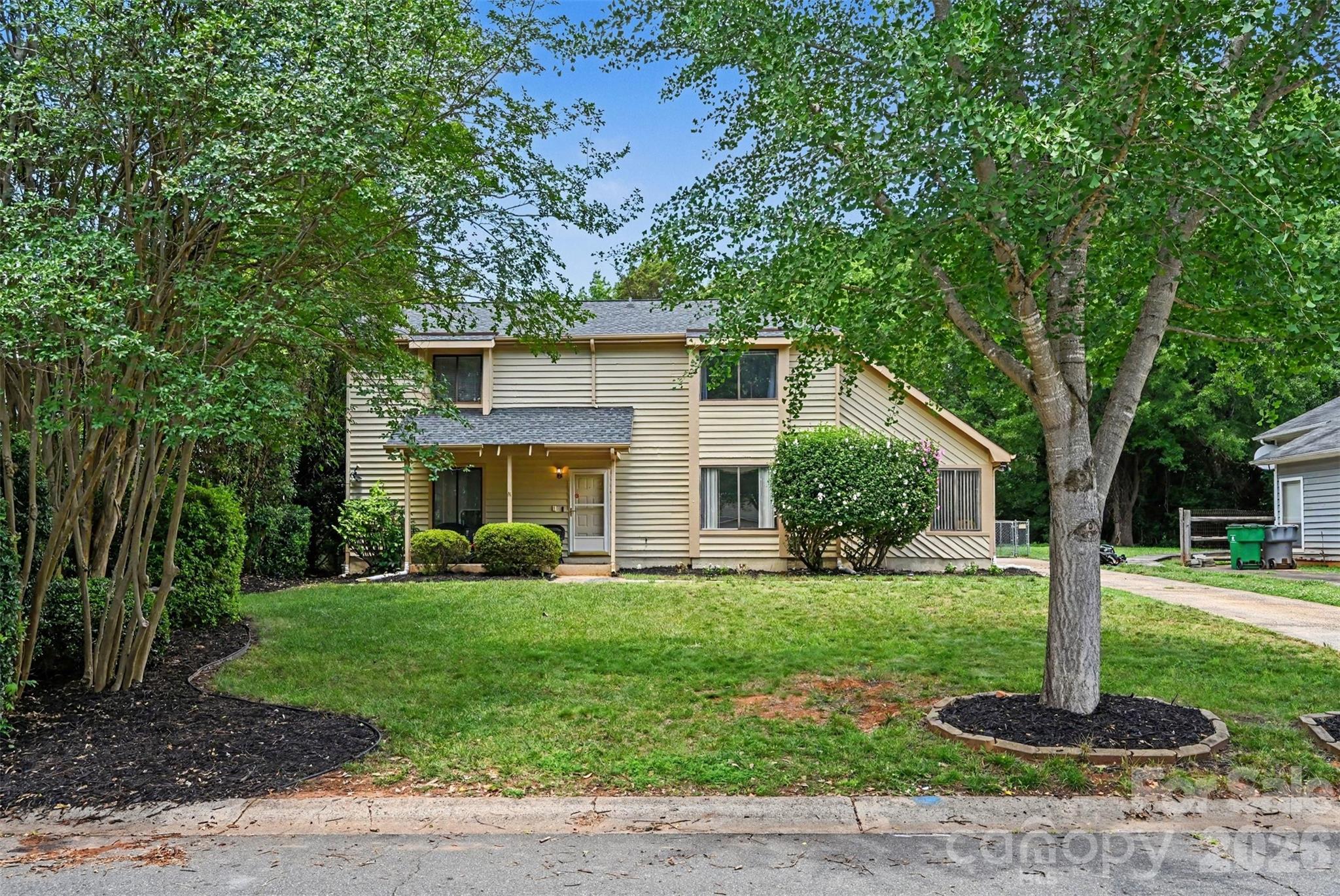 BEAUTIFUL MOVE IN READY HOME IN A PRIME CHARLOTTE LOCATION OF HIGH TIMBERS SUBDIVISION. This spacious 4 bedroom, 2.5 bath home offers a versatile floor plan with both the primary suite and a guest bedroom conveniently located on the main level. Freshly painted throughout, the home features an inviting layout designed for comfortable everyday living and entertaining.Enjoy vaulted ceilings in the formal dining room, a cozy den with a wood burning fireplace, a bright living room with a charming window seat, and generously sized secondary bedrooms. The updated kitchen includes updated countertops, stainless steel appliances, a range hood, breakfast area, and a convenient laundry closet.Recent upgrades include luxury vinyl plank flooring and updated bathroom vanities. Outside, you'll find mature landscaping, a fully fenced backyard, and lush privacy shrubs surrounding the patio perfect for relaxing or entertaining.Additional highlights include a newer HVAC system, ample storage, and NO HOA. Conveniently located near shopping, dining, parks, and major commuter routes, this home is ready for its next owner to move right in and enjoy!